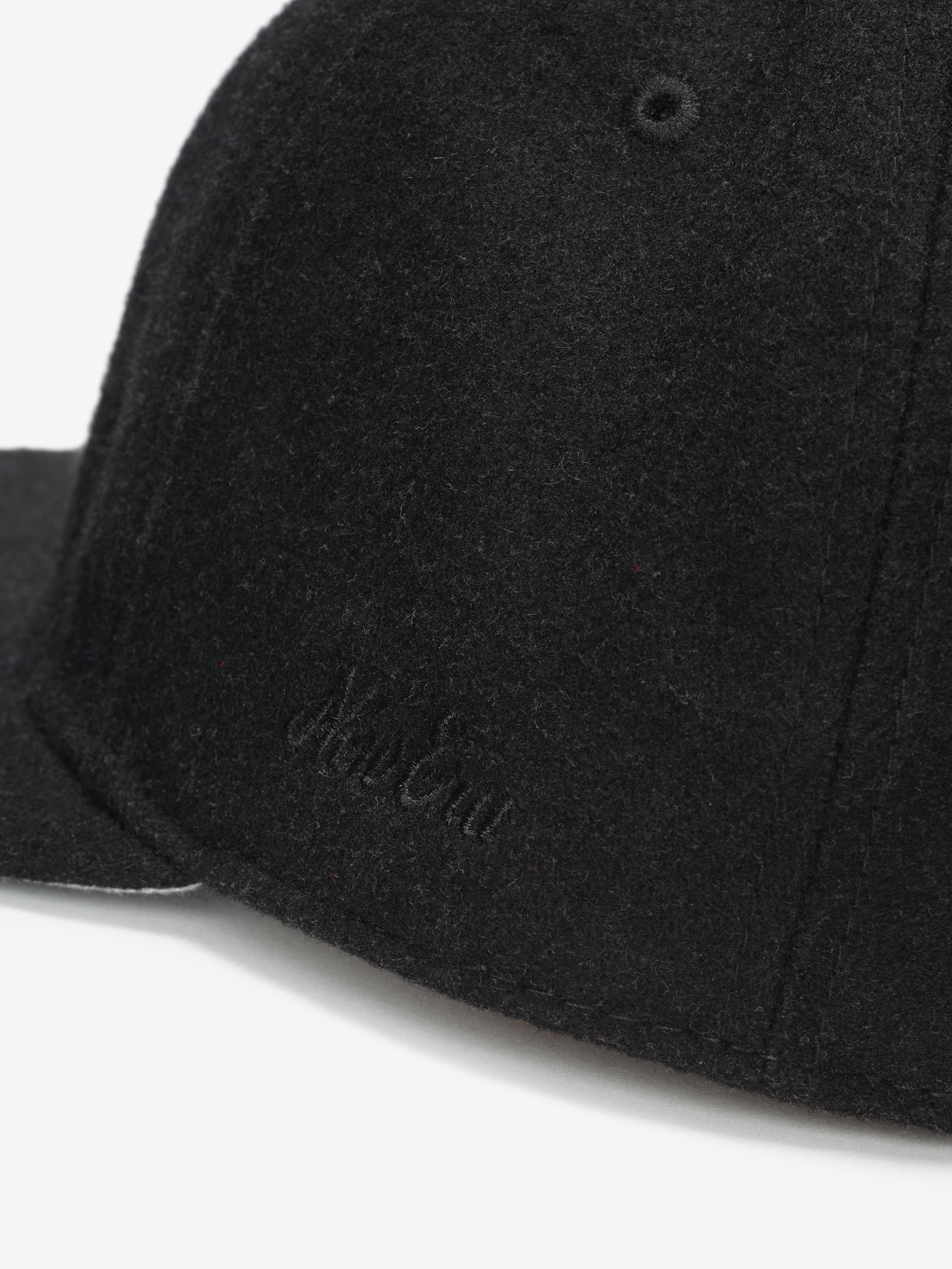 Fear of God Essentials 59FIFTY Retro Fitted American League Cap in black wool blend with close-up detail of subtle tonal embroidered branding on the structured side panel.