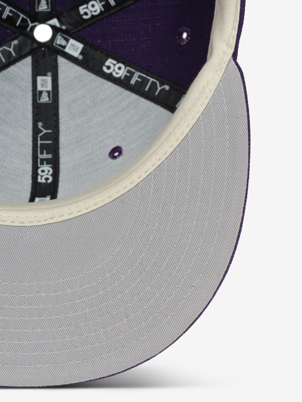 Colorado Rockies 59FIFTY Cap showing the interior view with light grey underbill, cream-colored trim, and black branded taping along the structured purple panels.