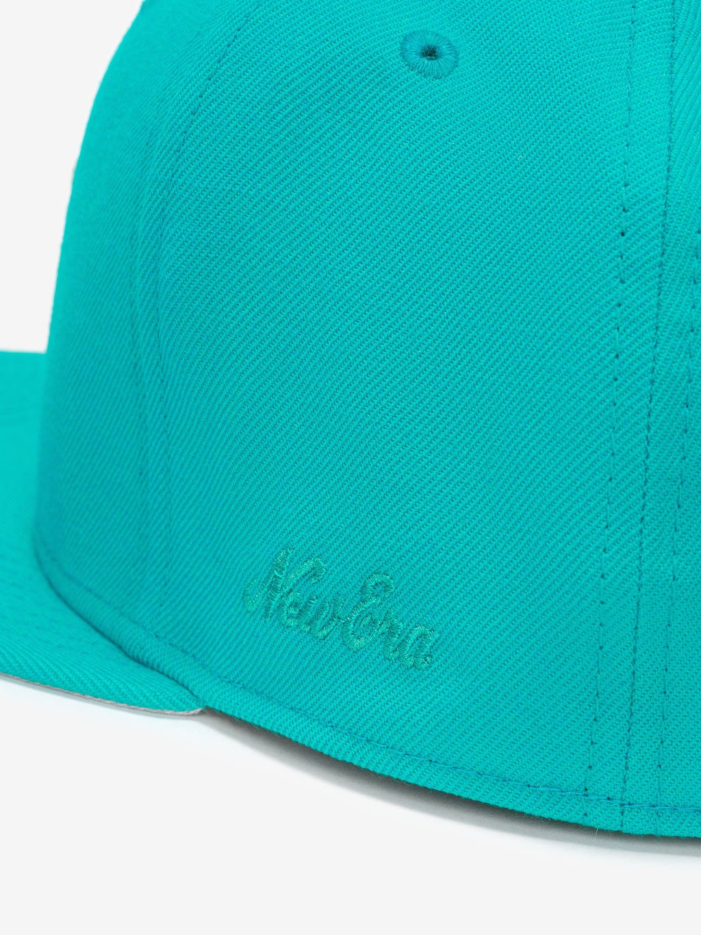 Miami Marlins 59FIFTY Cap in vibrant teal highlighting a close-up of the side panel with subtle tonal embroidered New Era branding and detailed stitching.