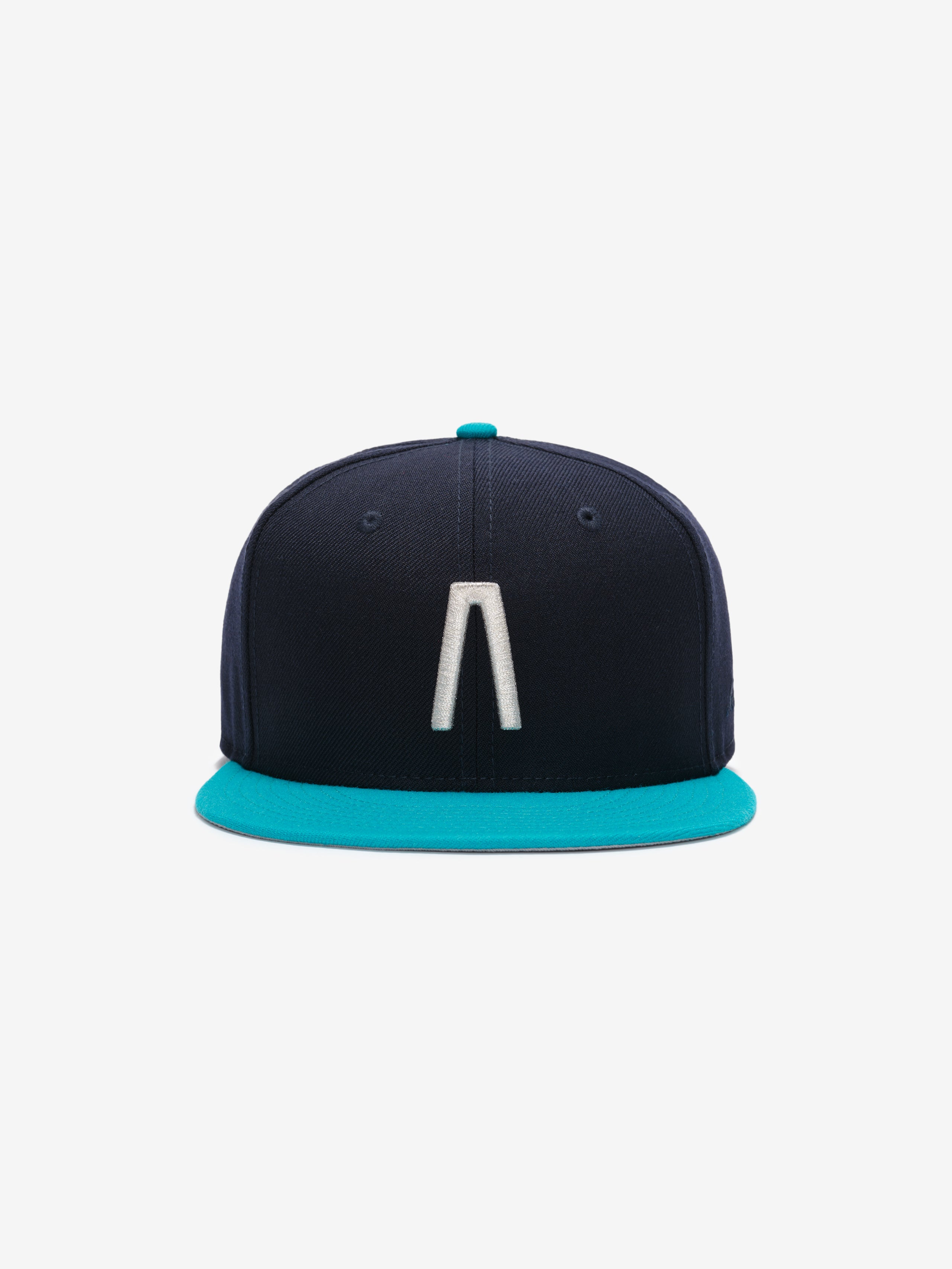 Fear of God Essentials 59FIFTY Athletics Cap in navy with a contrasting turquoise flat brim, featuring a raised white embroidered minimalist logo on the front panel.