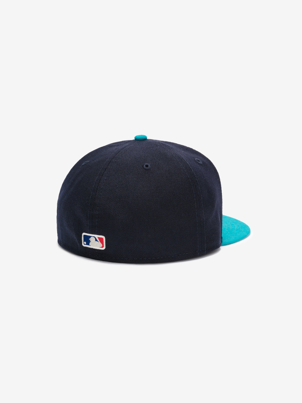 Fear of God Essentials 59FIFTY Athletics Cap shown from the rear, featuring a deep navy crown with a contrasting turquoise flat brim and the MLB logo embroidered near the base.