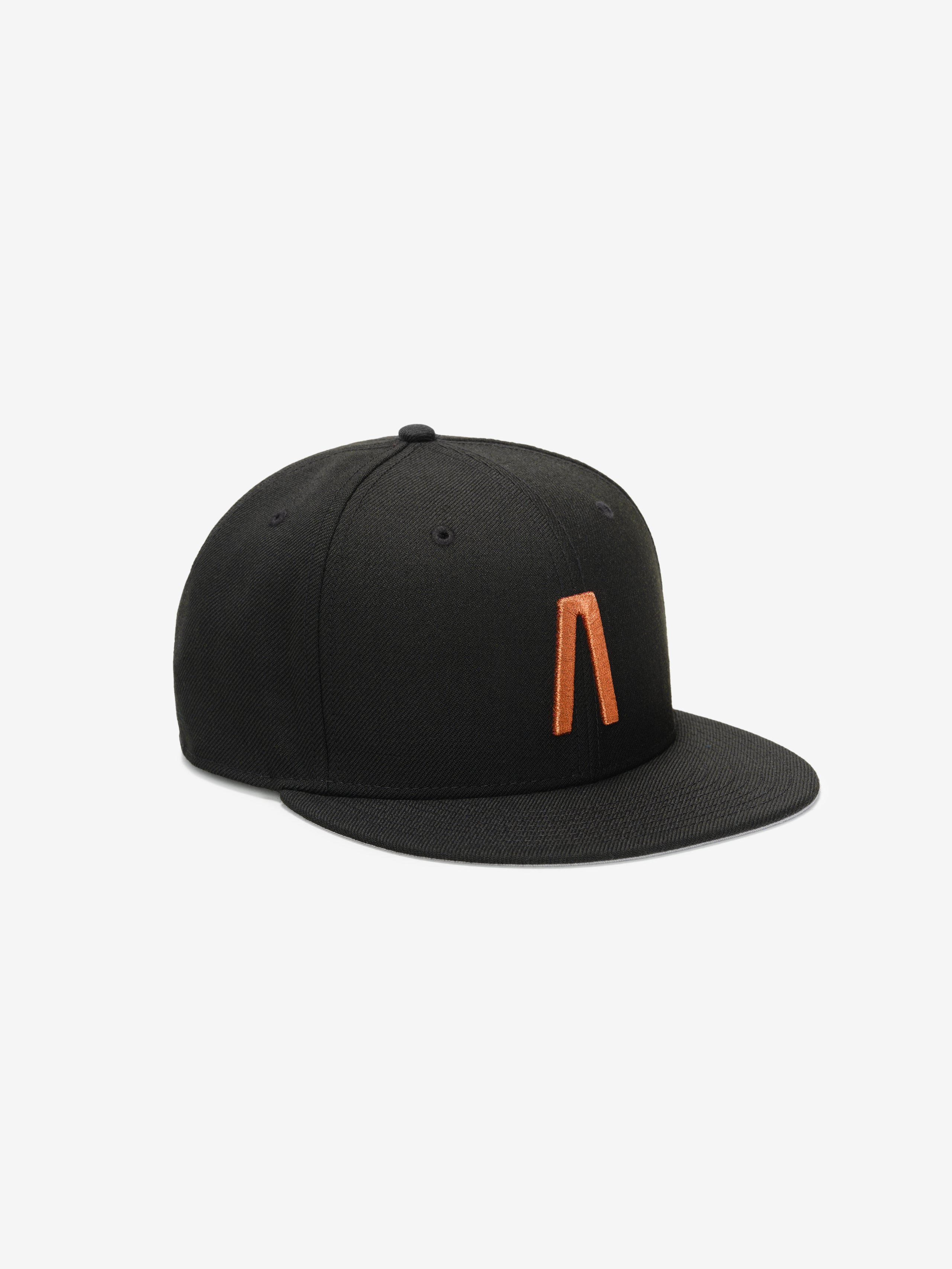 Fear of God Essentials 59FIFTY Athletics Cap in black featuring a flat brim and a distinctive orange minimalist emblem embroidered on the front panel.