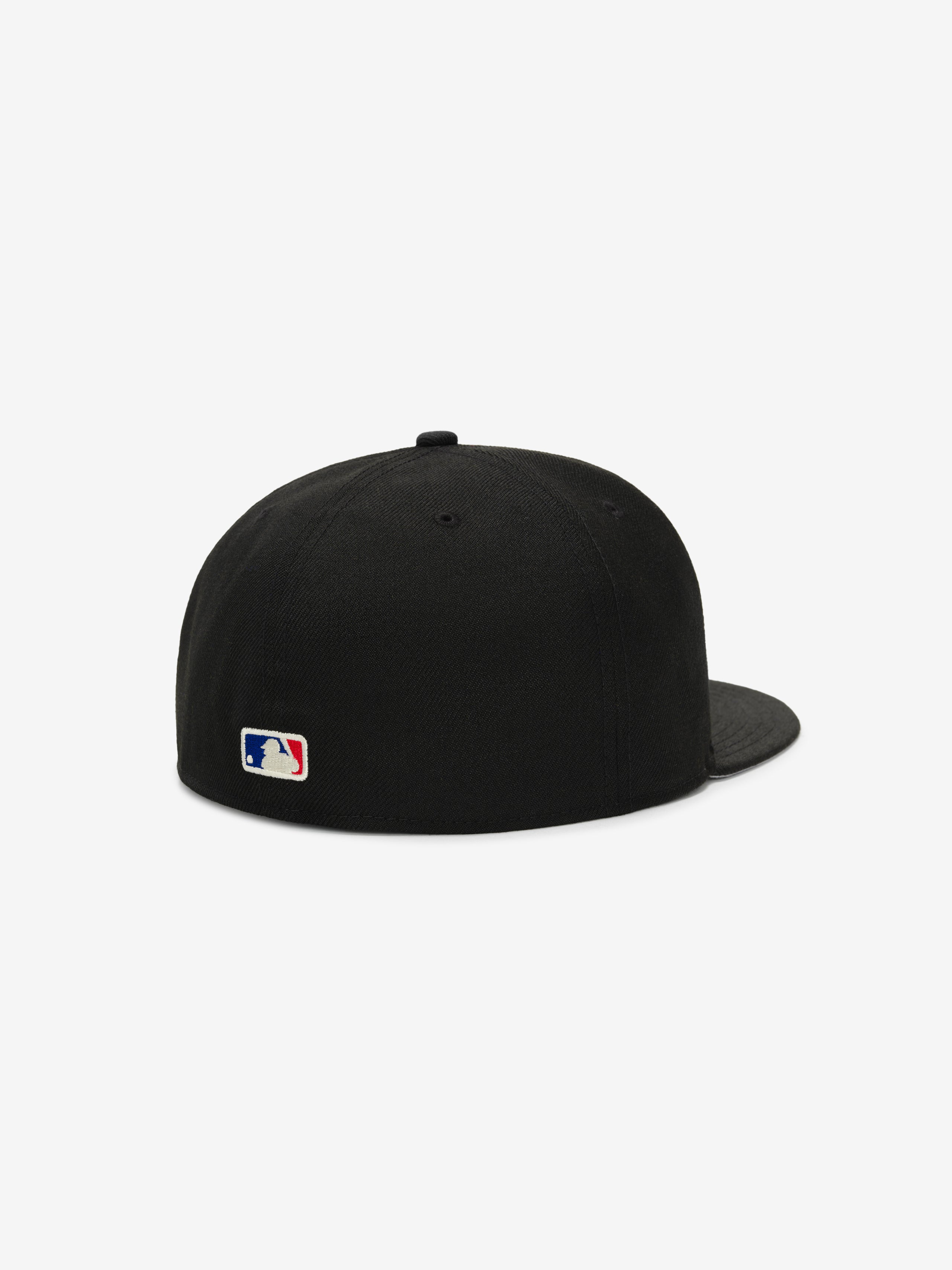 Fear of God Essentials 59FIFTY Athletics Cap shown from the back, featuring a solid black crown with tonal black stitching, a matching flat brim, and a small MLB logo embroidered near the base.