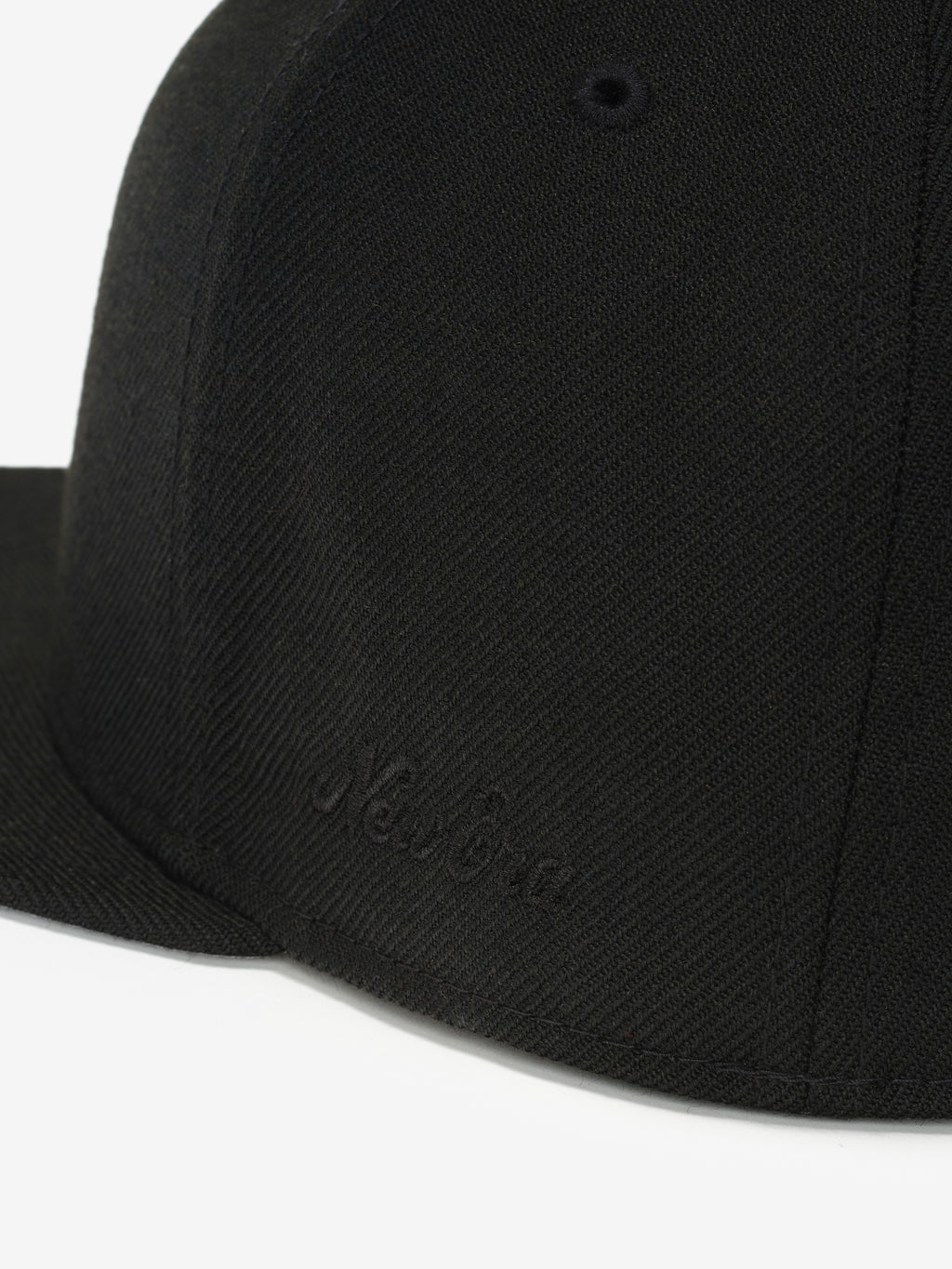 Fear of God Essentials 59FIFTY Athletics Cap featuring a solid black fabric with tonal black New Era embroidered branding on the side and a structured flat brim.