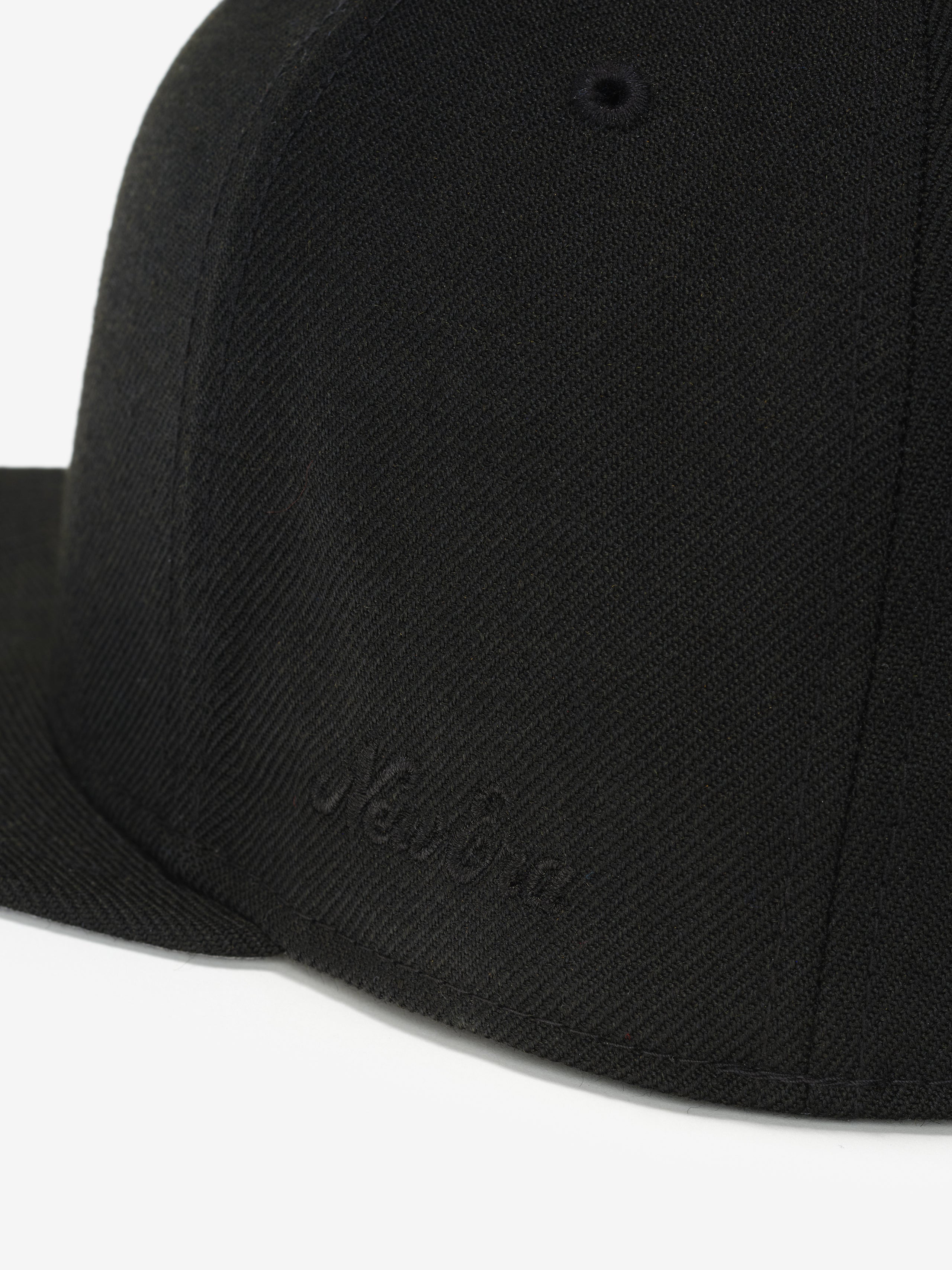 Fear of God Essentials 59FIFTY Athletics Cap featuring a solid black fabric with tonal black New Era embroidered branding on the side and a structured flat brim.