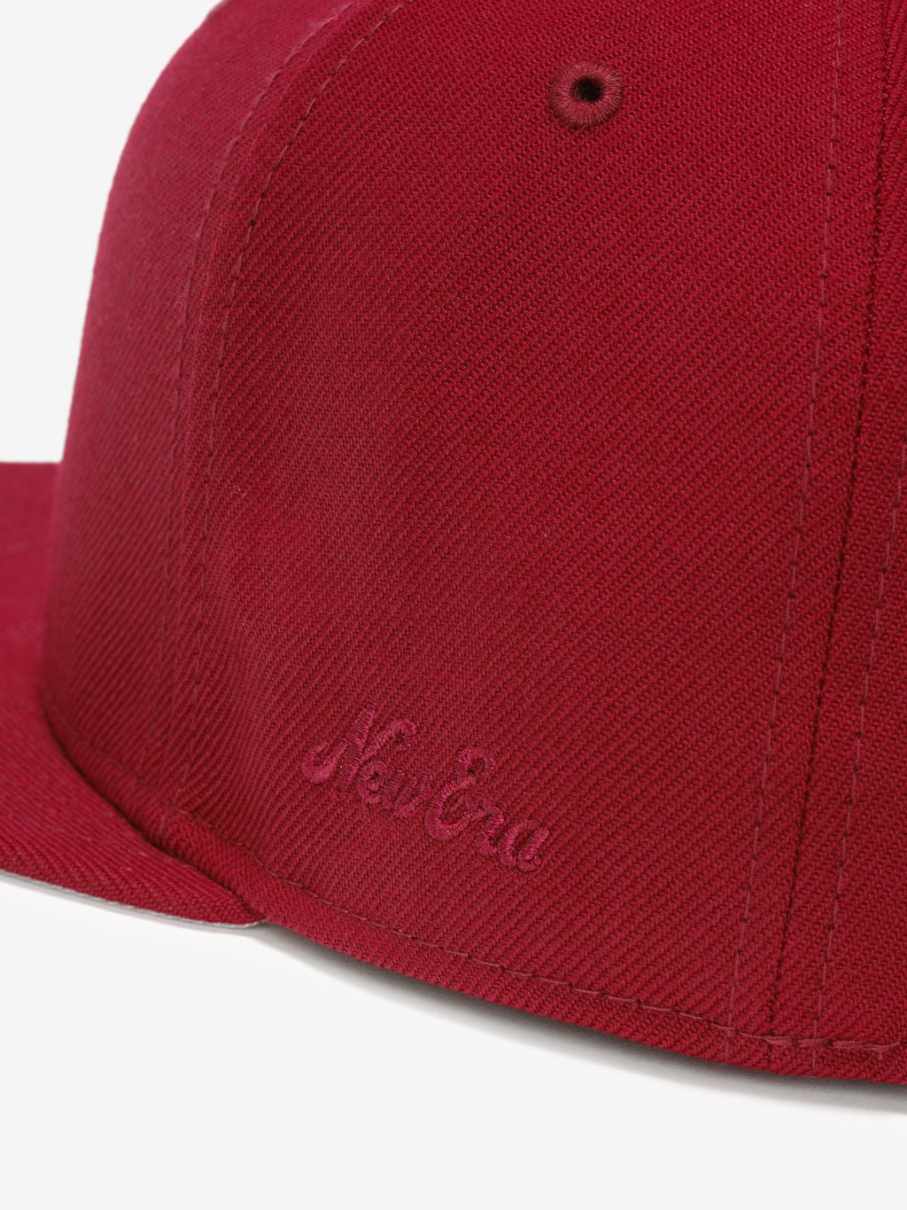 Fear of God Essentials 59FIFTY Athletics Cap in deep crimson fabric, featuring a tonal embroidered New Era logo near the base of the structured flat brim.