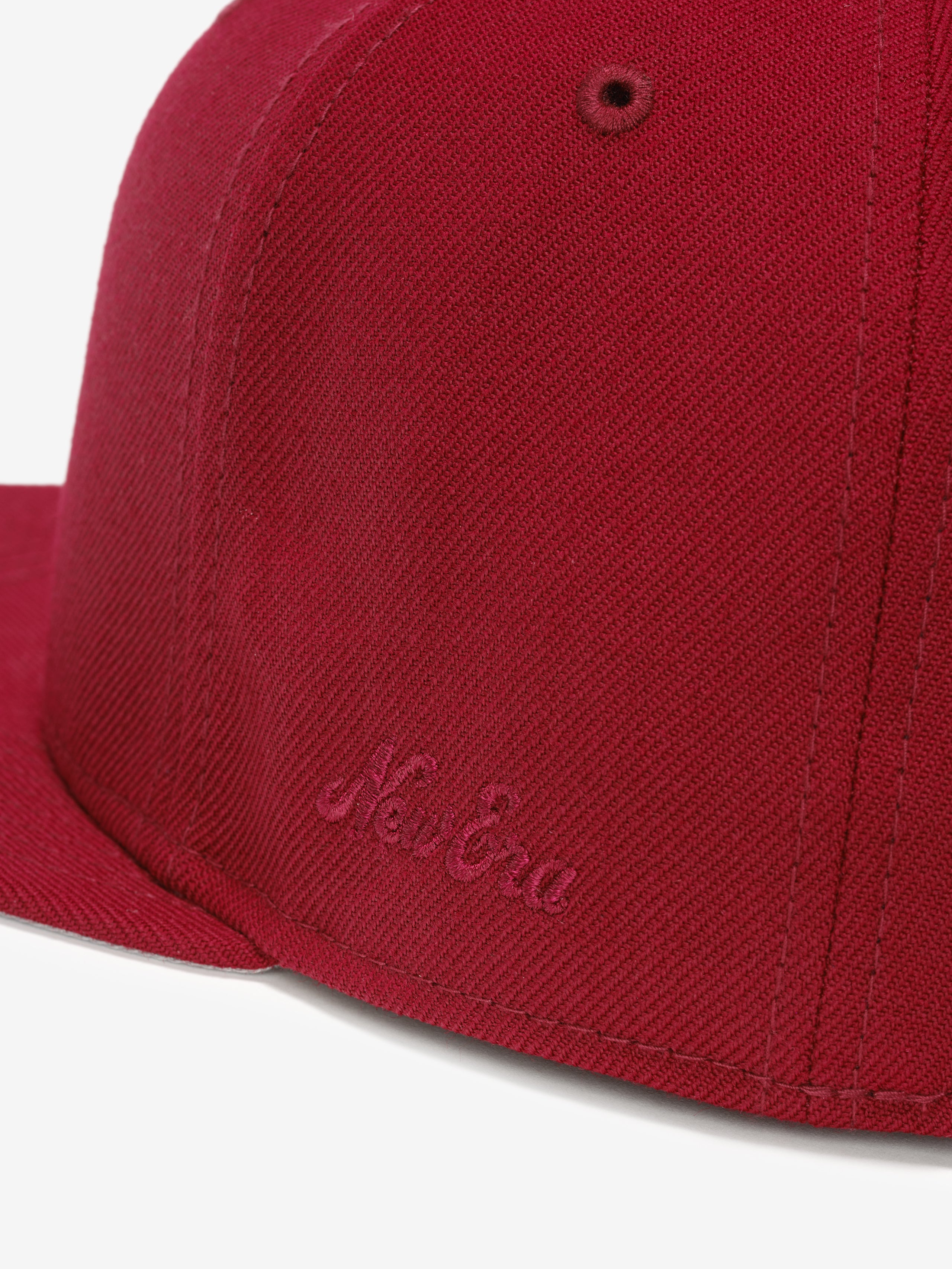 Fear of God Essentials 59FIFTY Athletics Cap in deep crimson fabric, featuring a tonal embroidered New Era logo near the base of the structured flat brim.