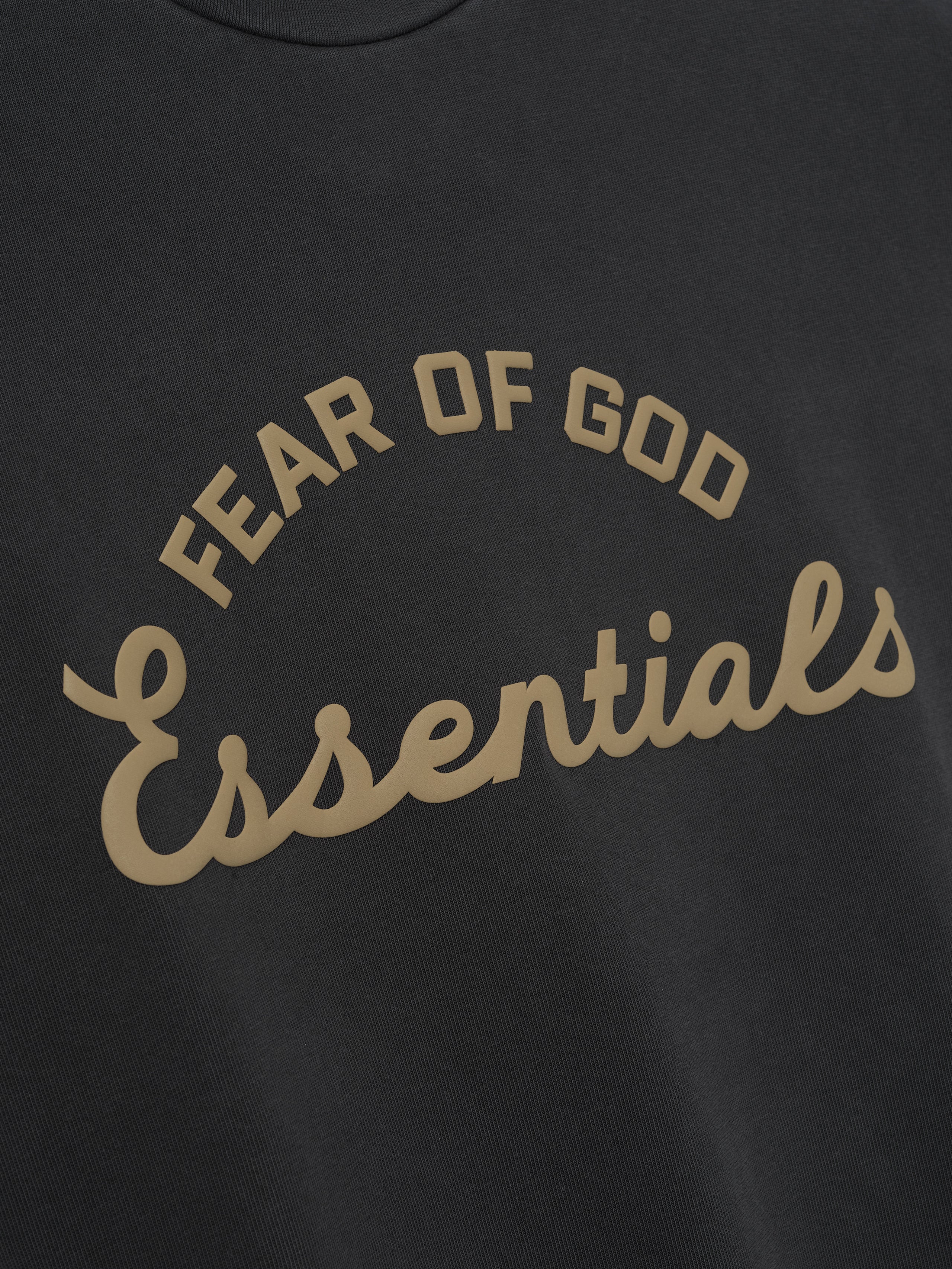 Black t-shirt with 'Fear of God Essentials' text in beige.