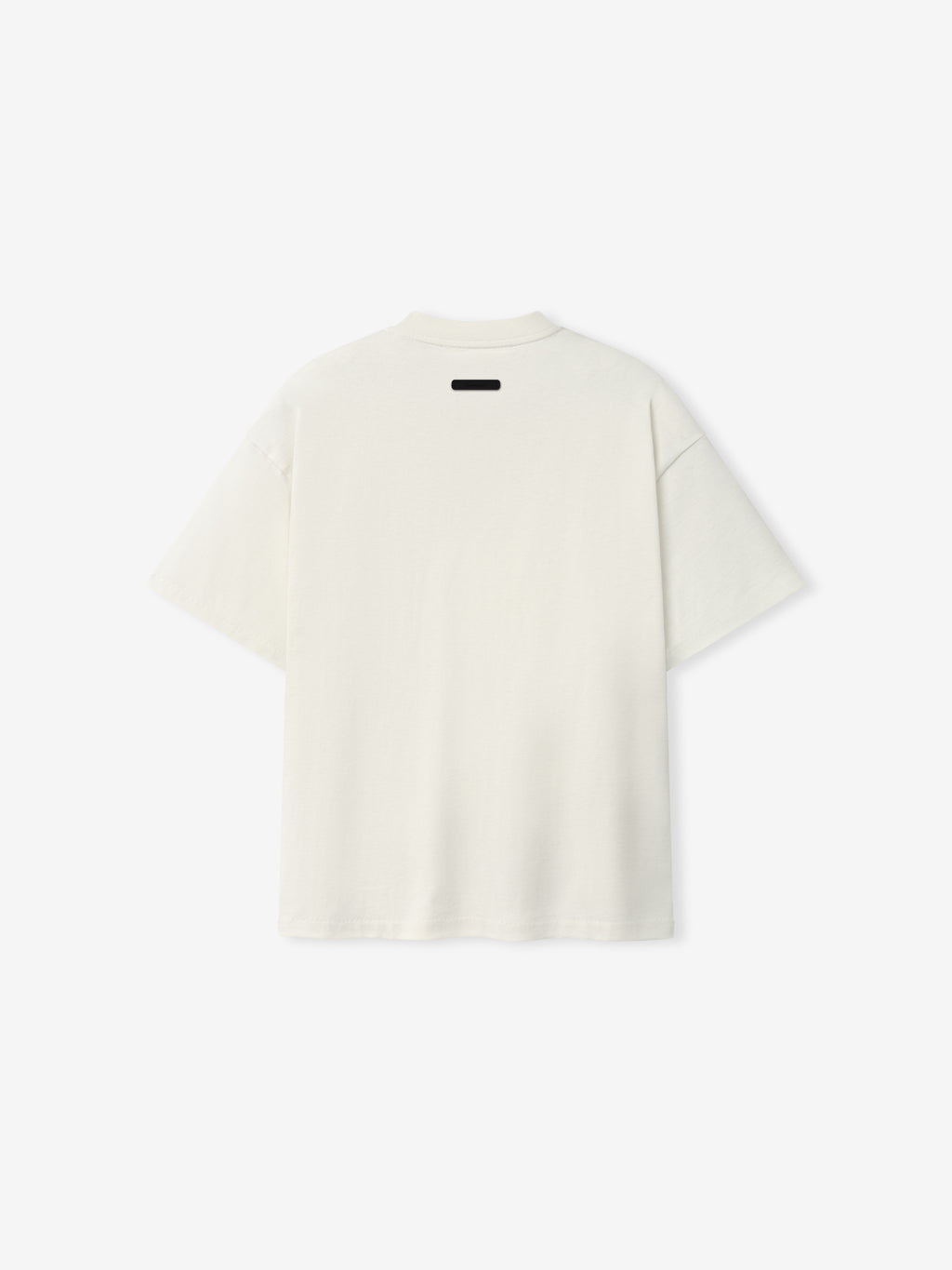 Back view of the Kids Signature 90s Tee in soft ivory fabric with a relaxed fit and a small black label detail at the neckline, designed for casual kids' wear.