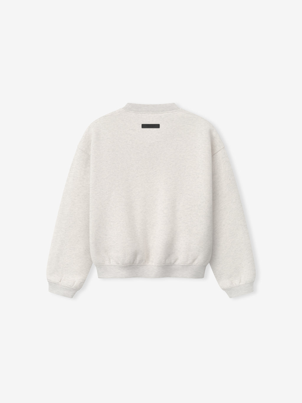 Back view of light beige crewneck sweatshirt with small black rectangular label at upper center and ribbed cuffs and hem