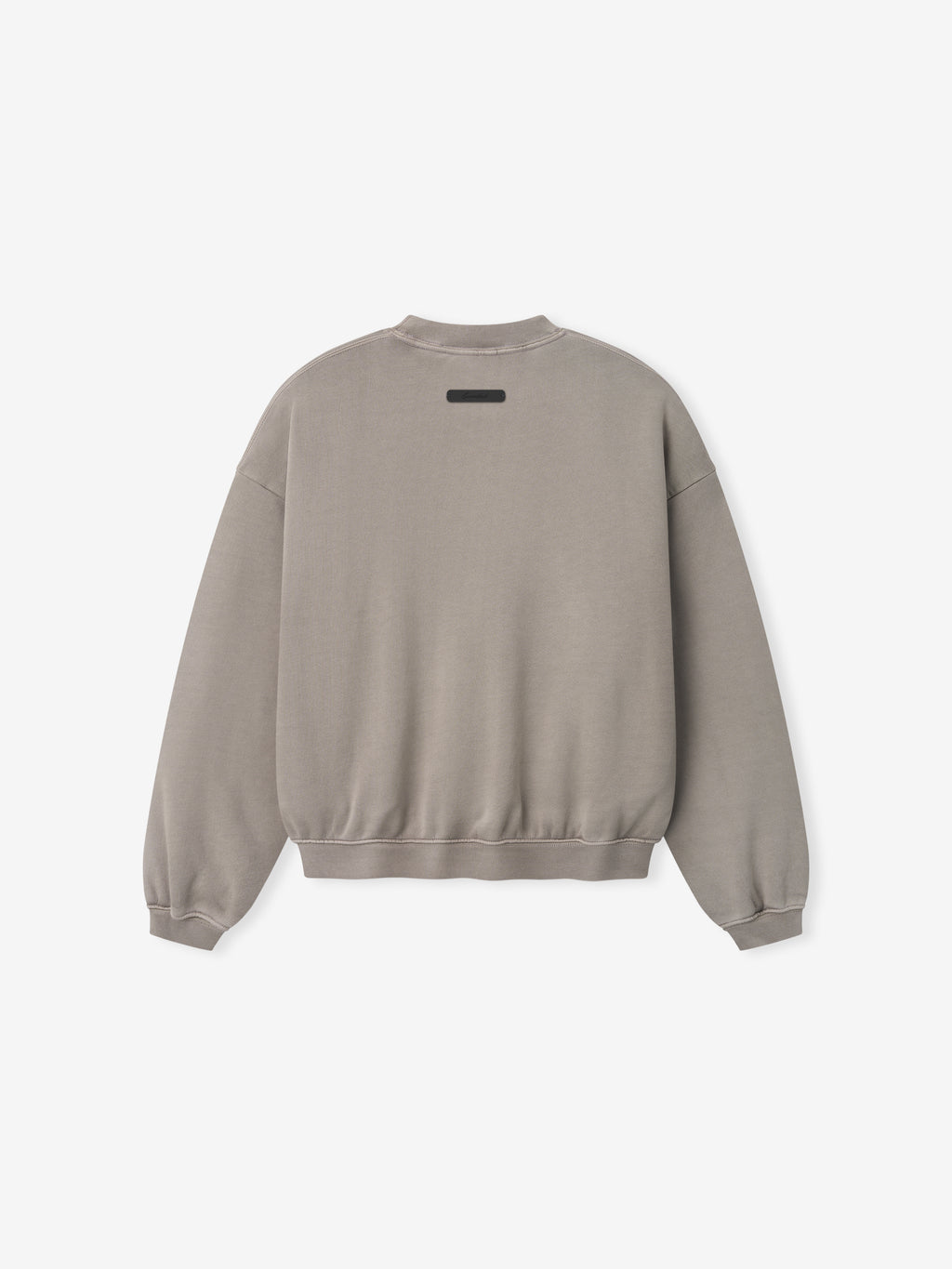 Light grey crewneck sweatshirt shown from back with ribbed cuffs and waistband and small rectangular patch near neckline