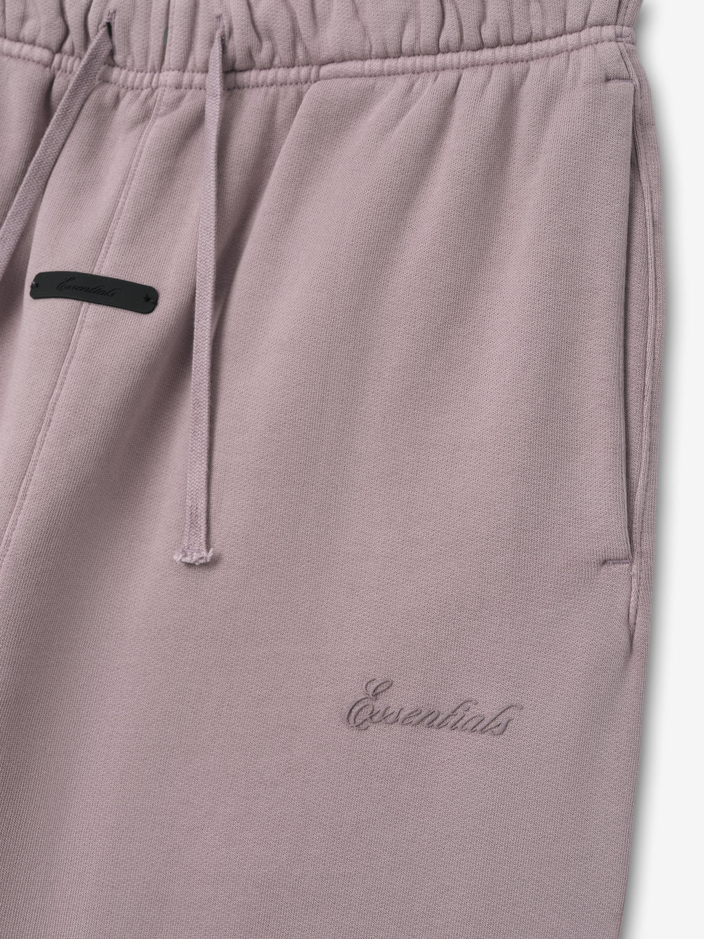 muted mauve kids sweatpant with pigment-dyed cotton fleece, embroidered Essentials logo, drawstring waistband, and side pockets