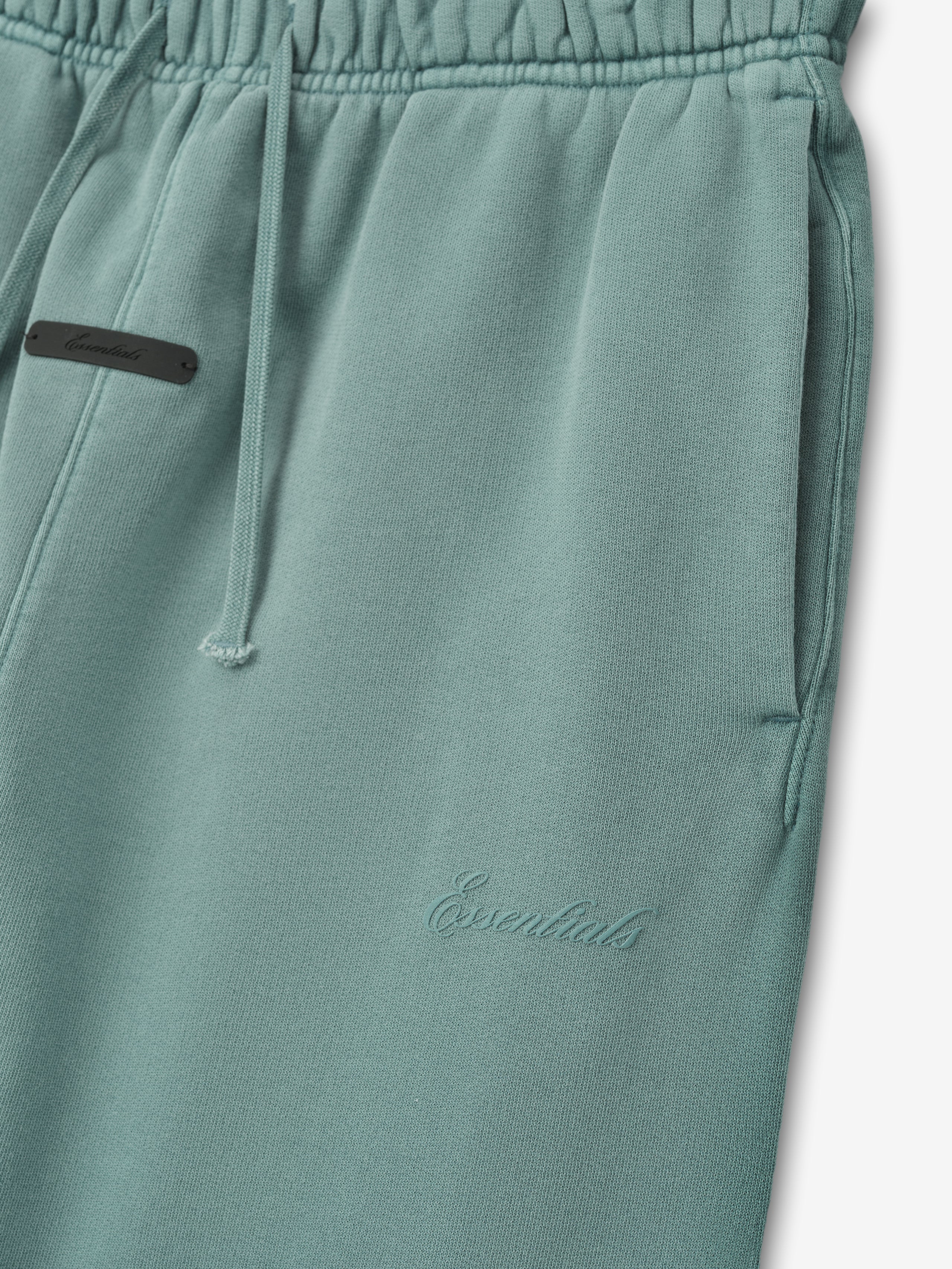 muted teal kids flare sweatpant in heavyweight cotton fleece with embossed Essentials logo and drawstring waistband