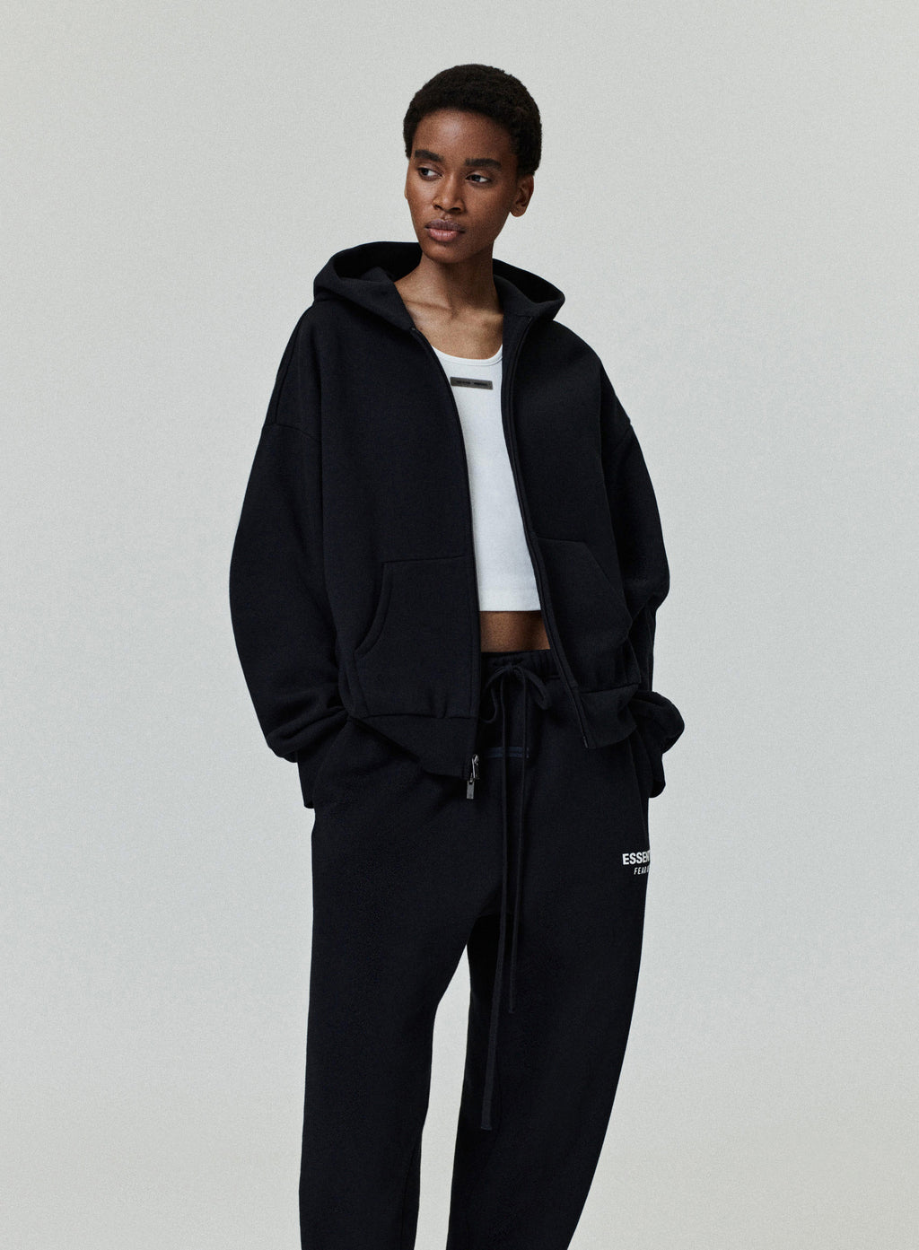 Front angled view of model wearing black Classic Full Zip-Up Hoodie with relaxed fit, gallery image 0