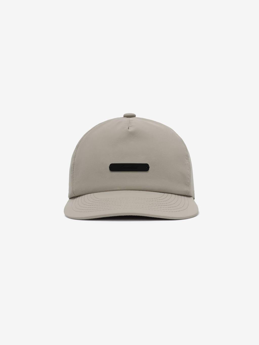 5 Panel Nylon Hat in muted beige featuring a sleek, minimal design with a small black rectangular logo plaque centered on the front panel for casual, versatile headwear.