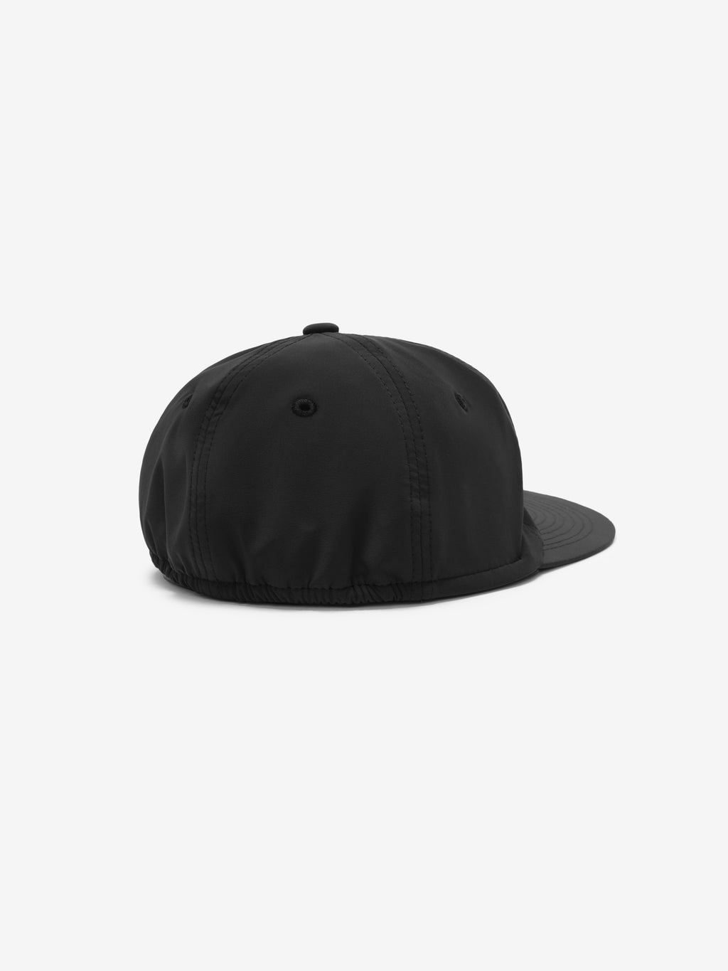 5 Panel Nylon Hat in vintage black with a smooth nylon fabric, subtle ventilation eyelets, and an elasticated back for a secure and comfortable fit.