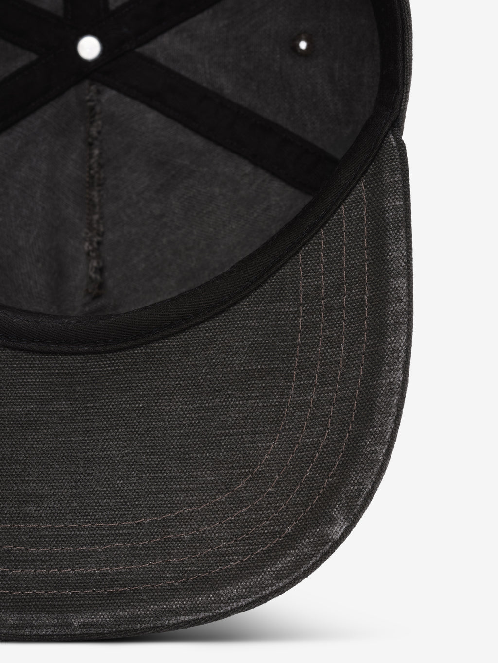 Canvas Baseball Cap in black closeup highlighting the curved brim textured canvas panels and tonal stitching for a casual finish