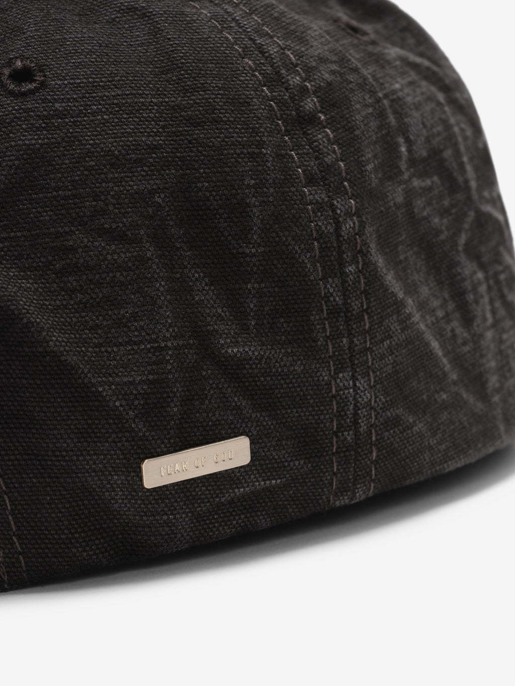 Canvas Baseball Cap in washed black closeup showing textured canvas panels tonal stitching and a small logo tab near the curved brim