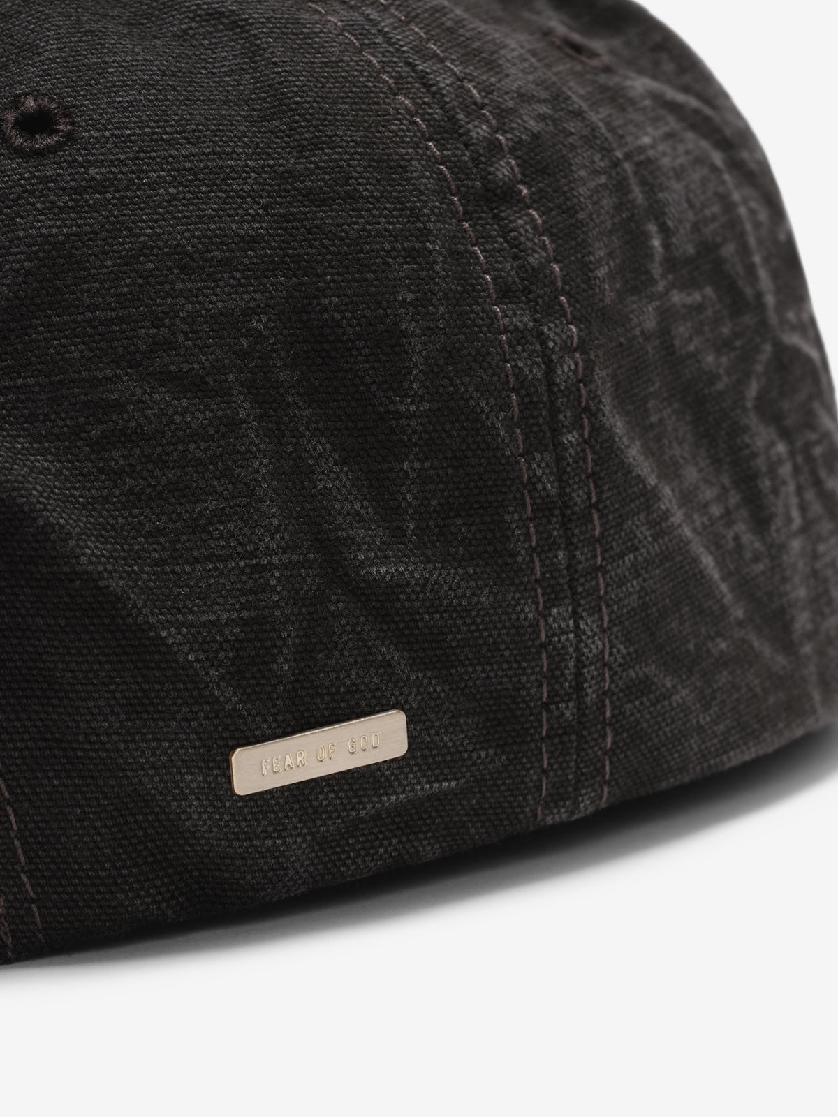 Canvas Baseball Cap in washed black closeup showing textured canvas panels tonal stitching and a small logo tab near the curved brim