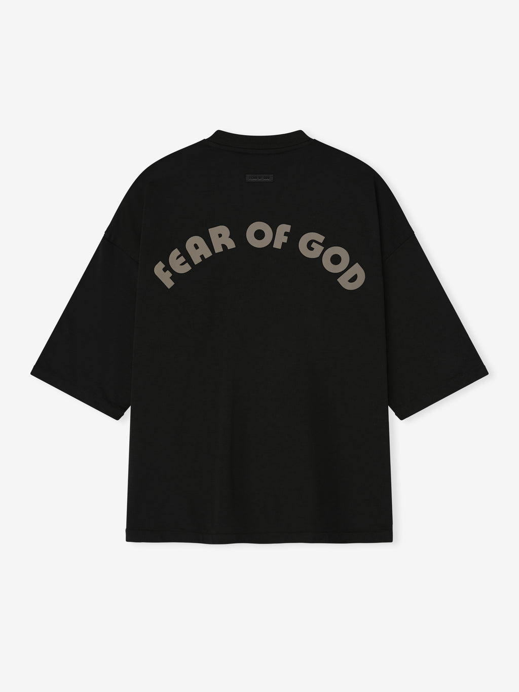 black oversized cotton-rayon tee with dropped shoulders and large curved "FEAR OF GOD" print on back