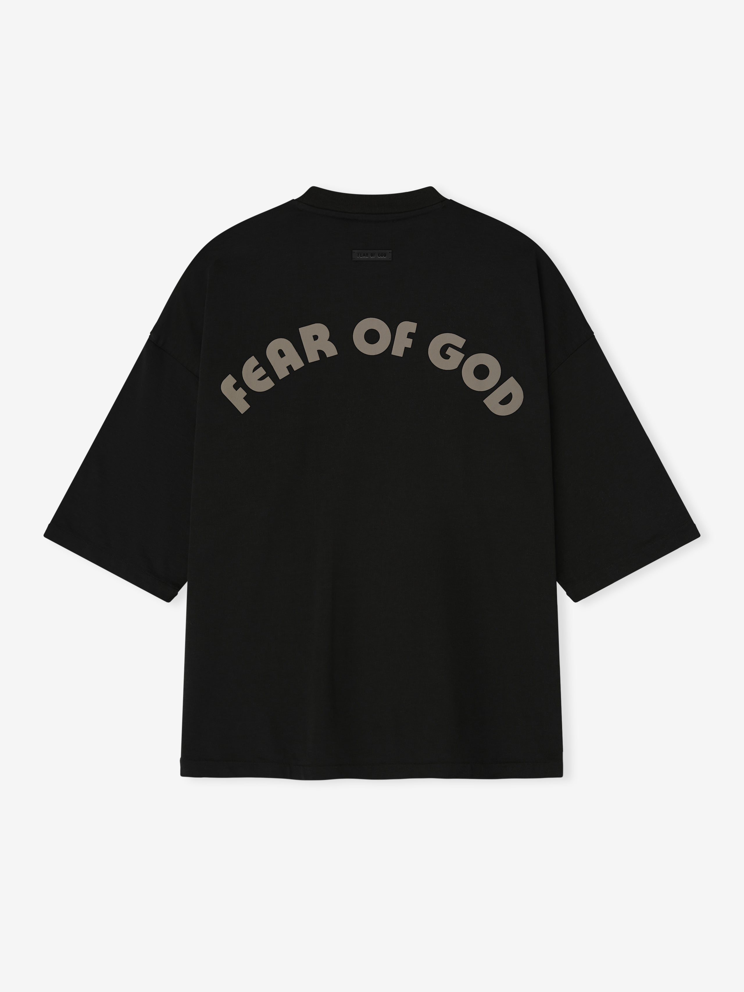 black oversized cotton-rayon tee with dropped shoulders and large curved "FEAR OF GOD" print on back