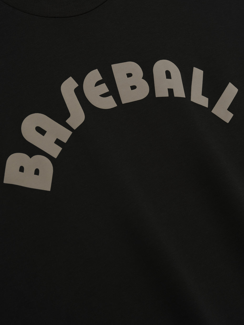 close-up of black cotton-rayon tee featuring large curved "BASEBALL" text in light gray across chest