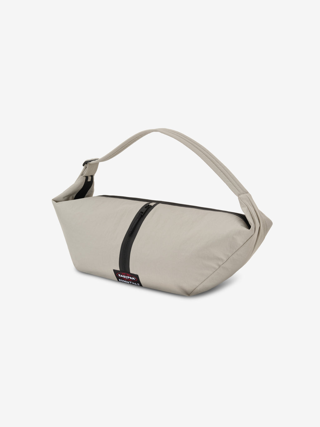 Essentials Shell Bag in light beige with a curved shoulder strap black zip detail and small woven label displayed against a clean white background