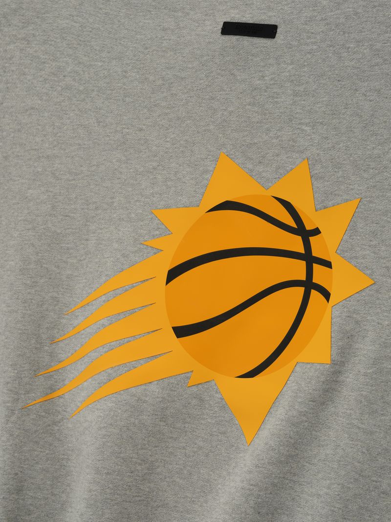 Close-up of grey Suns Sport Crewneck featuring bold orange and black basketball sunburst graphic on front center