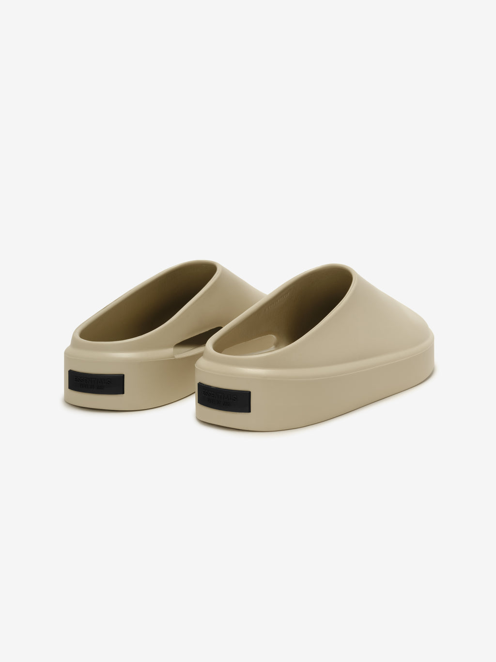 Essentials California 1.0 slip-on footwear in a beige shade, featuring a smooth, rounded silhouette with a minimalist, molded design for modern casual style and comfort.