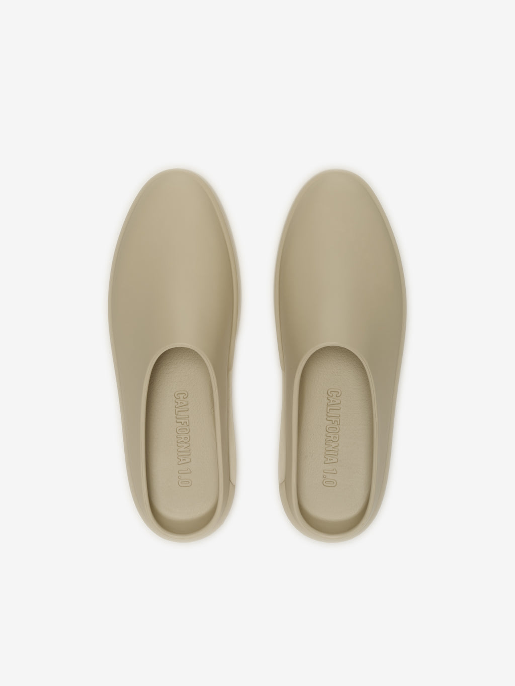 Essentials California 1.0 footwear in a muted beige tone, featuring a smooth, minimalist slip-on design with a streamlined silhouette for contemporary casual wear.