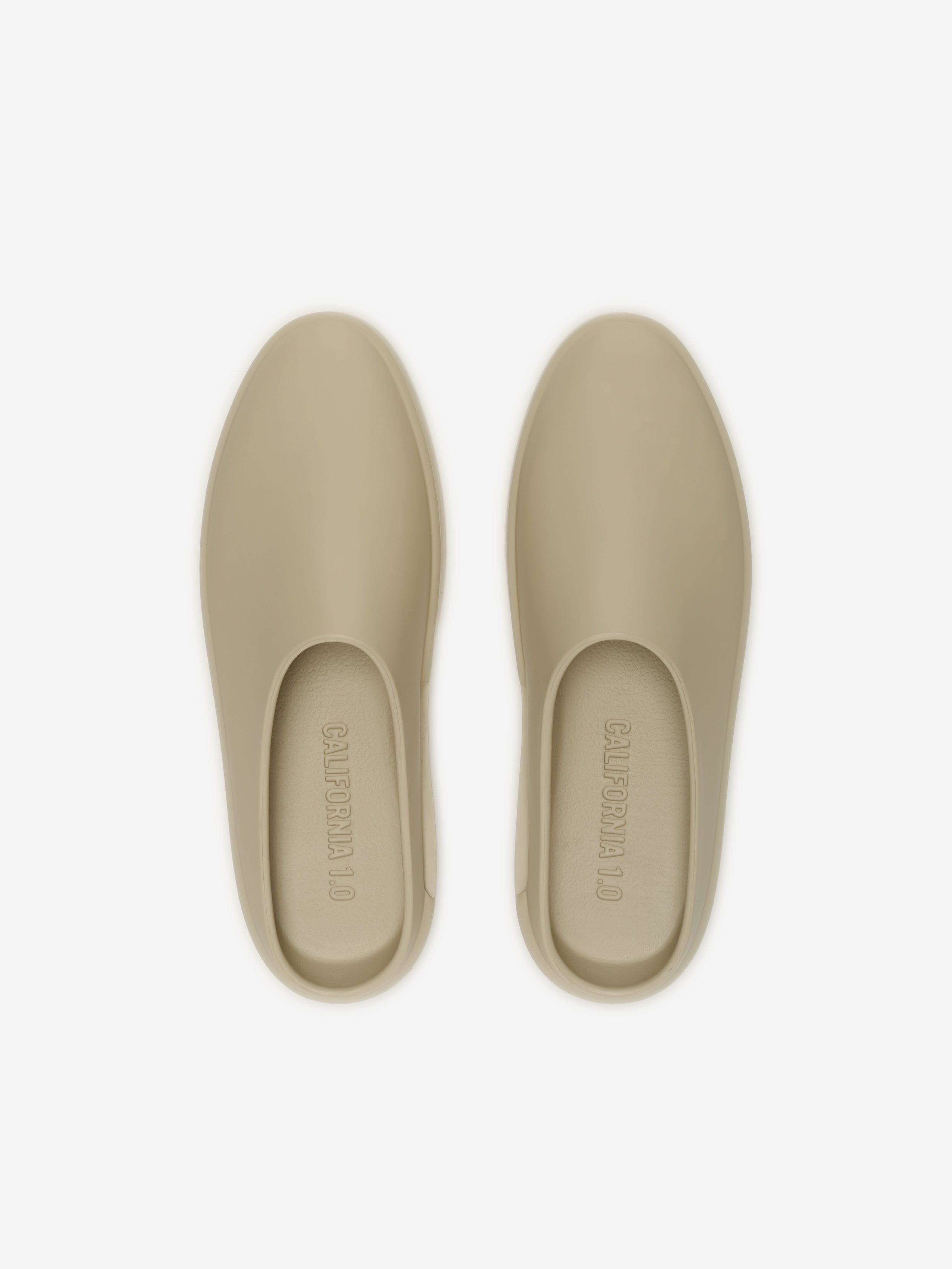 Essentials California 1.0 footwear in a muted beige tone, featuring a smooth, minimalist slip-on design with a streamlined silhouette for contemporary casual wear.