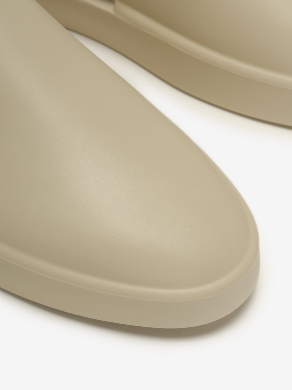 Essentials California 1.0 slip-on footwear in a soft beige tone, featuring a smooth, rounded toe and clean minimalist profile for versatile modern casual wear.