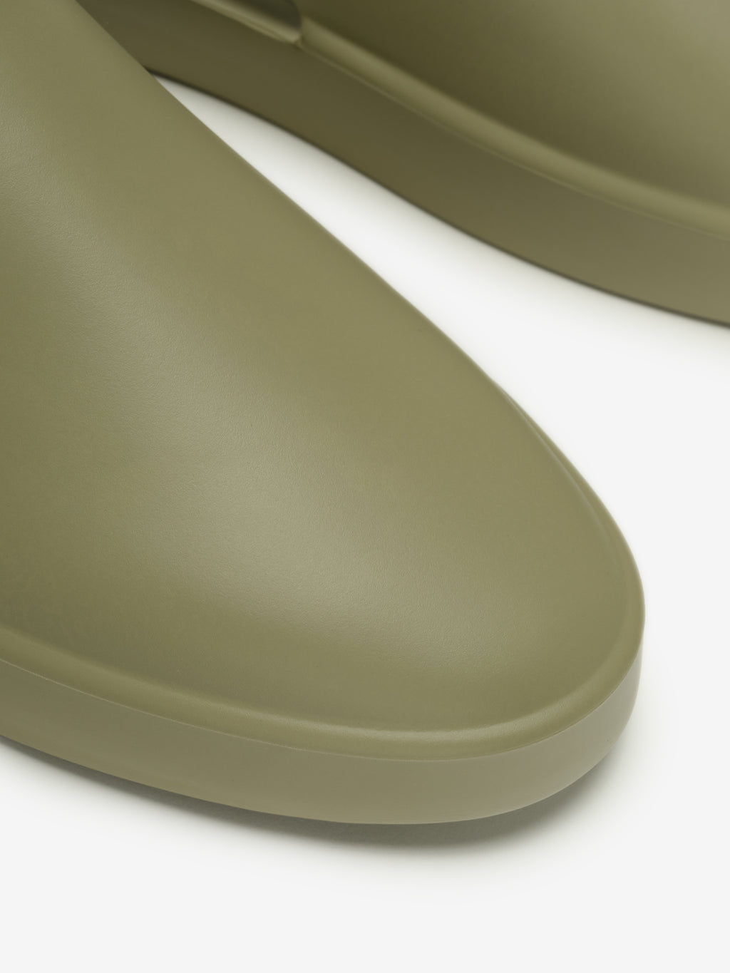 Essentials California 1.0 slip-on footwear in an olive shade, featuring a smooth, seamless toe design with a minimalist and modern molded silhouette for casual comfort.