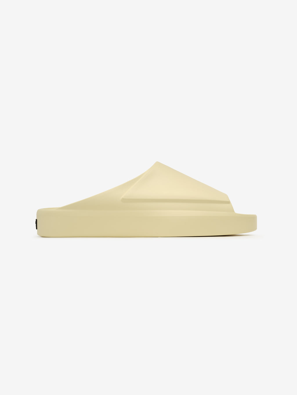 Essentials Los Feliz slip-on footwear in a soft almond shade featuring a sculpted, seamless upper with a thick, cushioned sole for elevated minimalist casual style.
