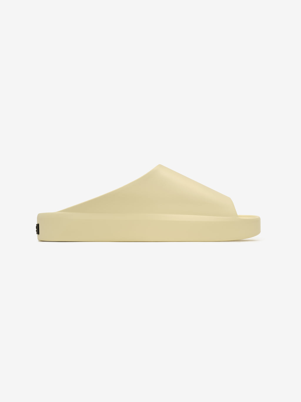 Essentials Los Feliz slip-on footwear in a smooth almond hue featuring a seamless sculpted upper and a thick cushioned sole for comfortable and minimalist modern style.