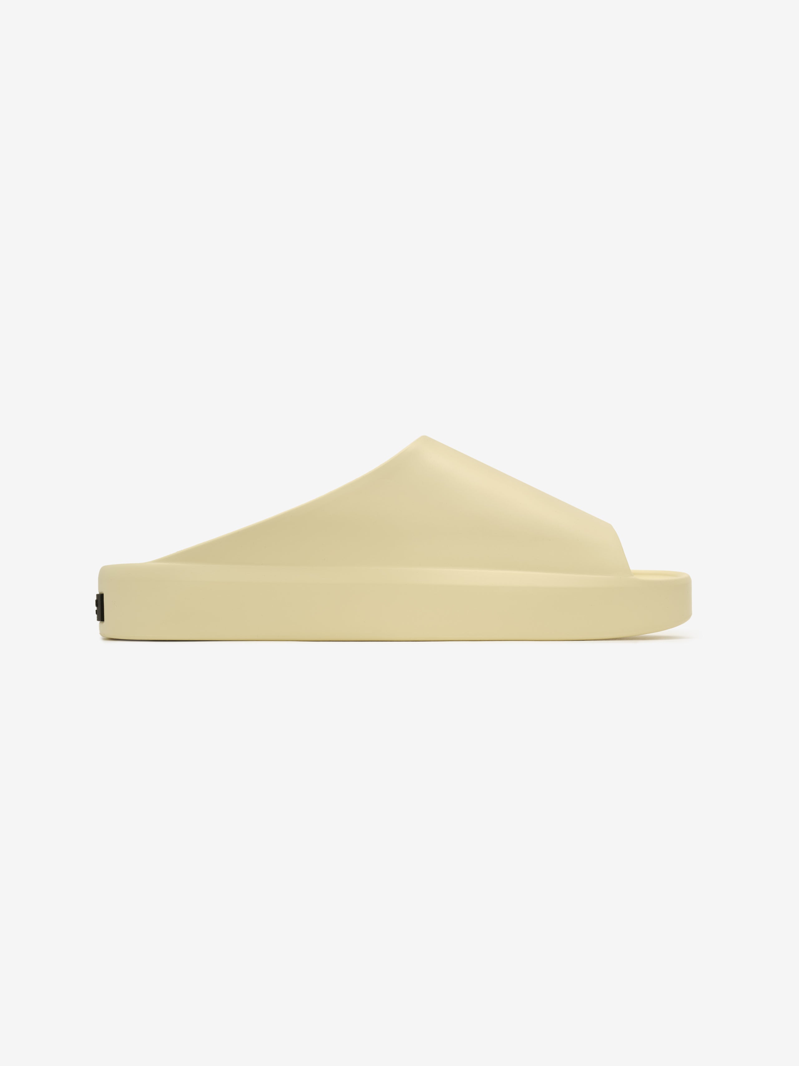 Essentials Los Feliz slip-on footwear in a smooth almond hue featuring a seamless sculpted upper and a thick cushioned sole for comfortable and minimalist modern style.
