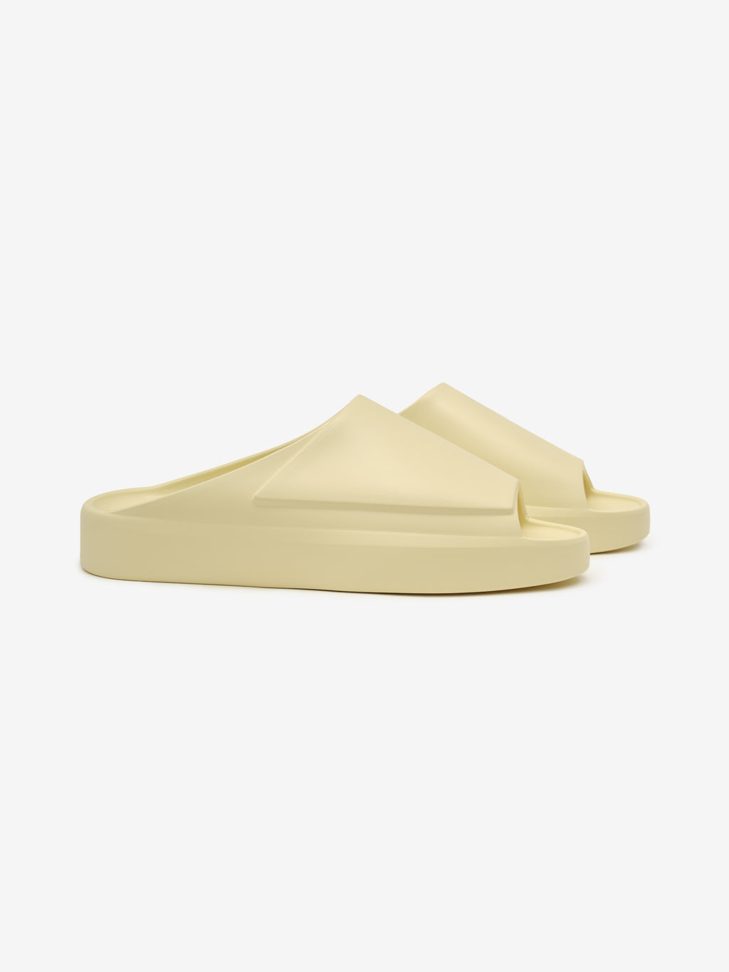 Essentials Los Feliz slip-on footwear in a soft almond tone featuring a smooth, contoured upper with a sculpted design and a thick cushioned sole for sleek, casual comfort.