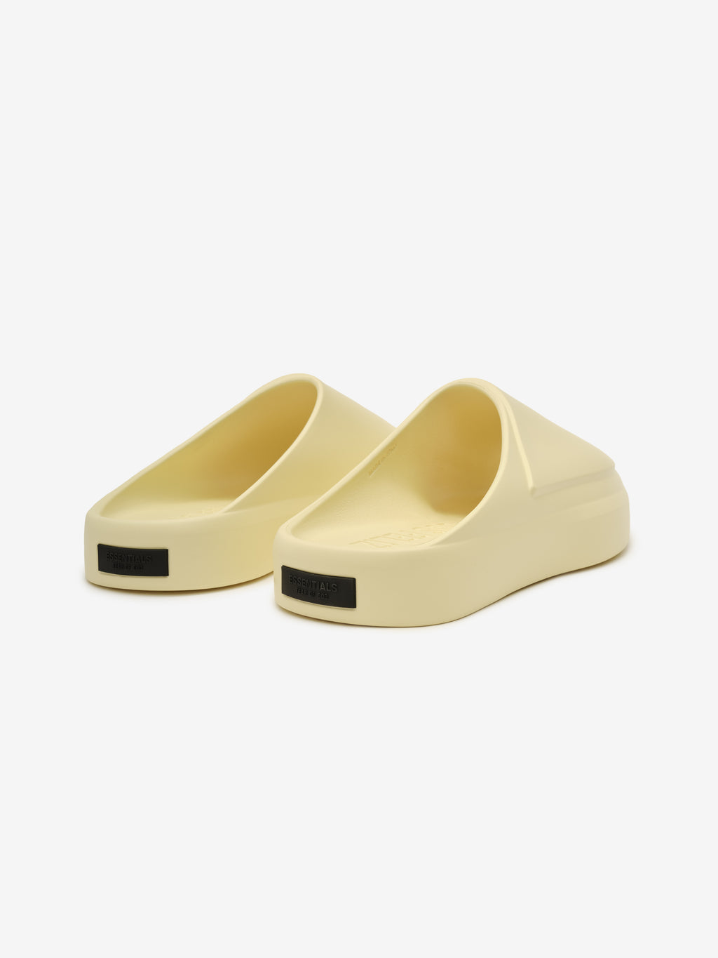 Essentials Los Feliz slip-on footwear in a pale almond tone featuring a smooth, contoured silhouette with a cushioned platform sole and a minimalist modern design.