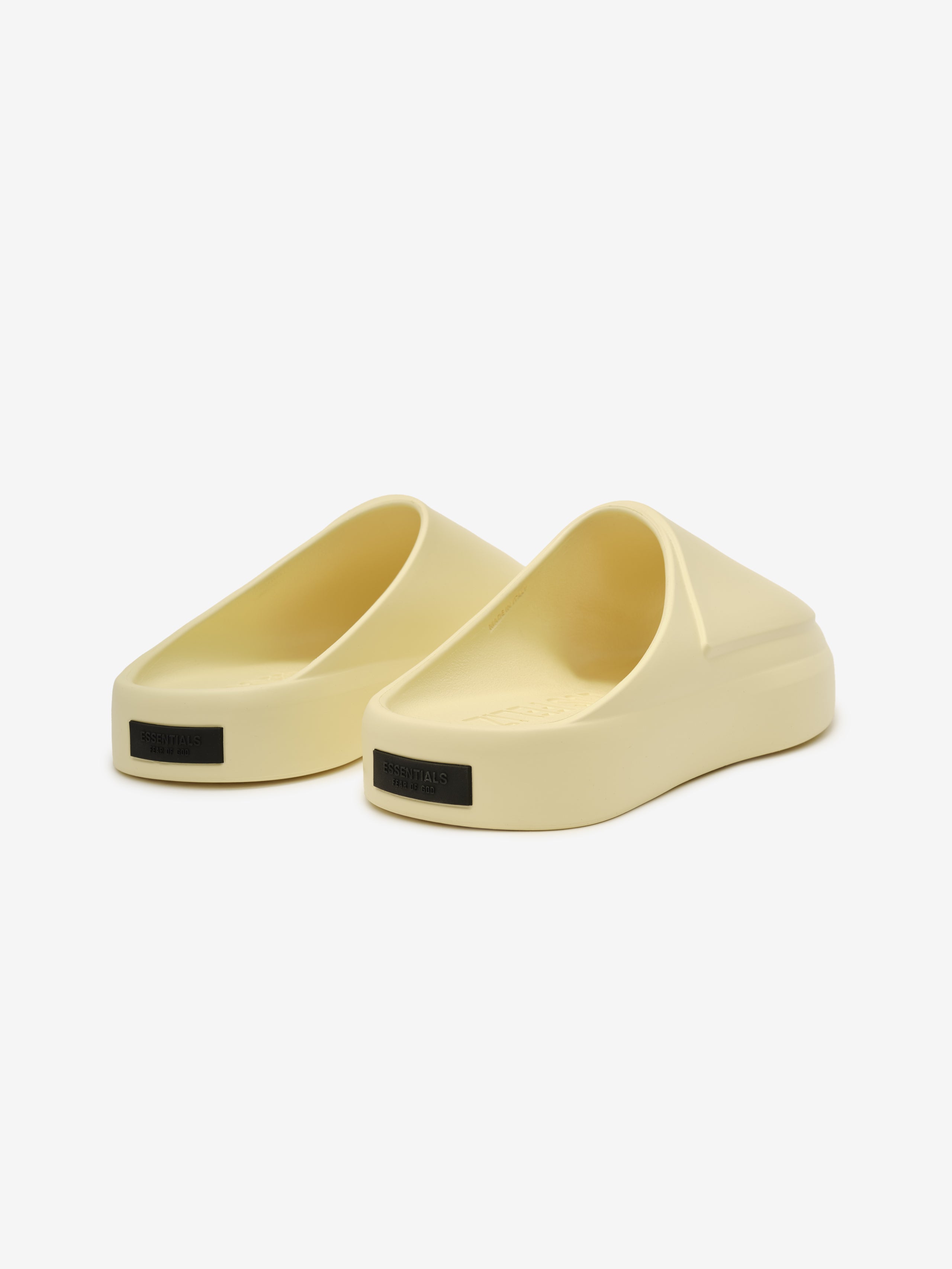 Essentials Los Feliz slip-on footwear in a pale almond tone featuring a smooth, contoured silhouette with a cushioned platform sole and a minimalist modern design.