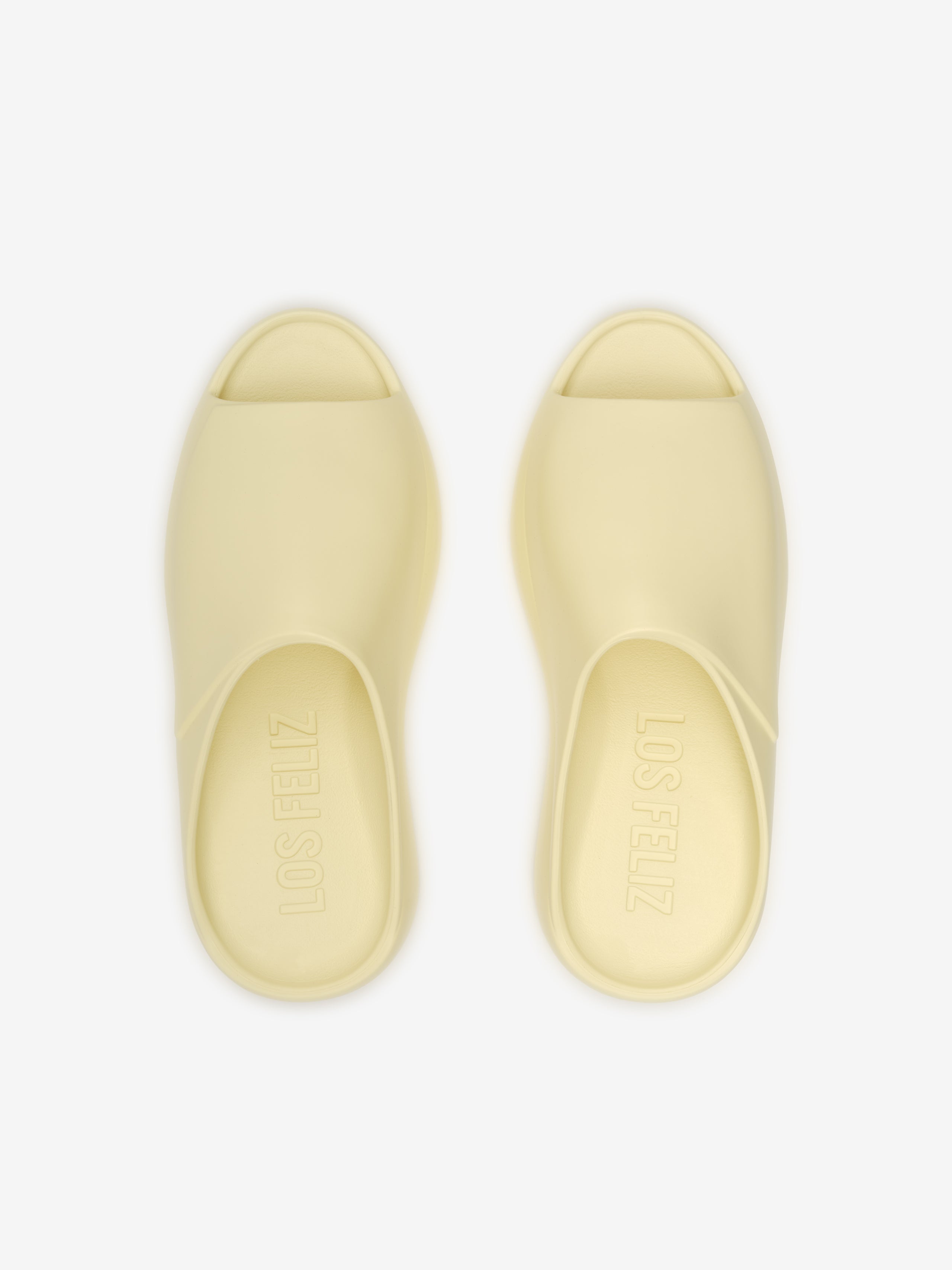 Essentials Los Feliz slip-on footwear in a smooth almond shade featuring a sleek, open-toe design with a contoured footbed for relaxed and modern casual comfort.