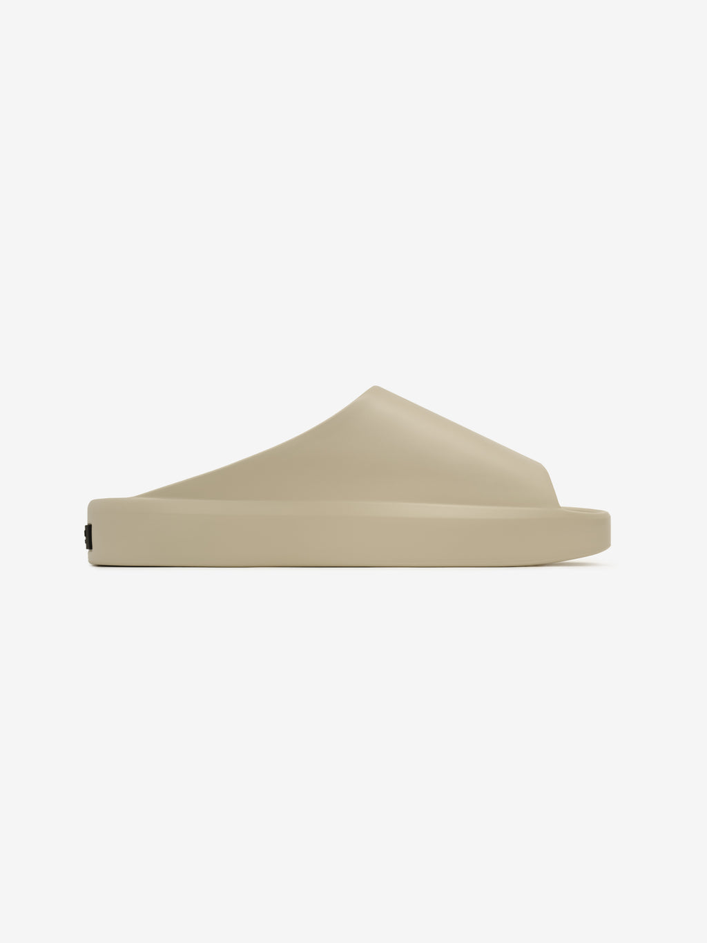 Essentials Los Feliz slip-on footwear in a soft beige shade featuring a smooth, contoured silhouette with a minimalist design and a slightly elevated sole for casual comfort.