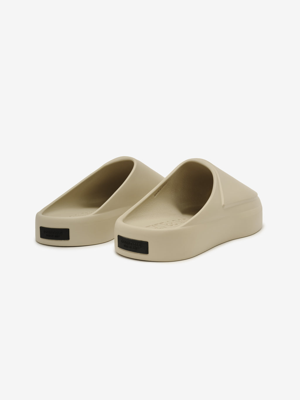 Essentials Los Feliz slip-on footwear in a smooth beige hue featuring a thick, cushioned sole and ergonomic sculpted design for easy, modern casual wear.