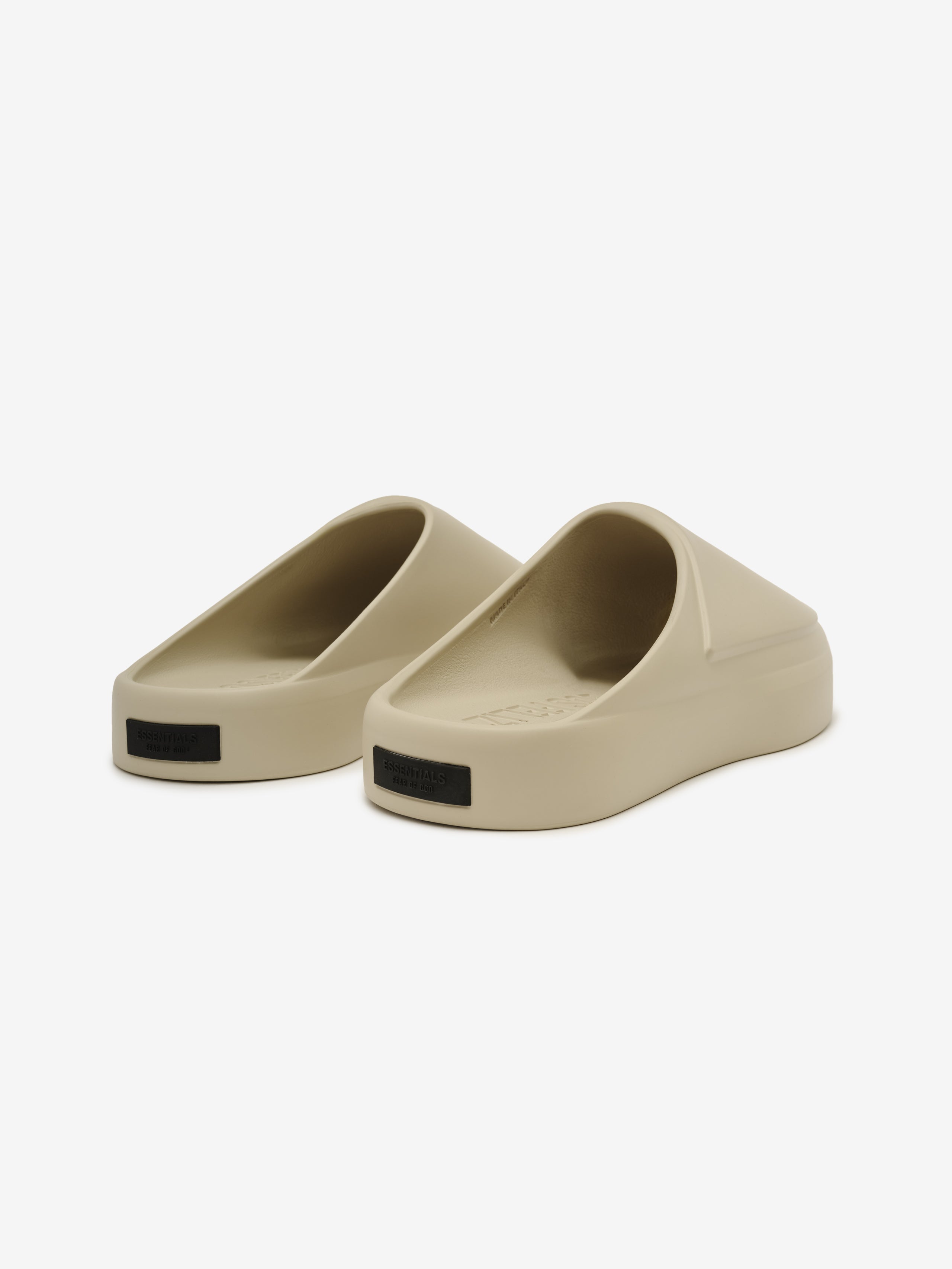 Essentials Los Feliz slip-on footwear in a smooth beige hue featuring a thick, cushioned sole and ergonomic sculpted design for easy, modern casual wear.