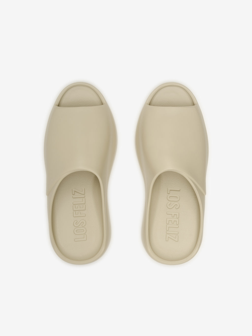 Essentials Los Feliz open-back slip-on footwear in a muted beige shade featuring a smooth, seamless upper and cushioned footbed for relaxed, modern casual style.