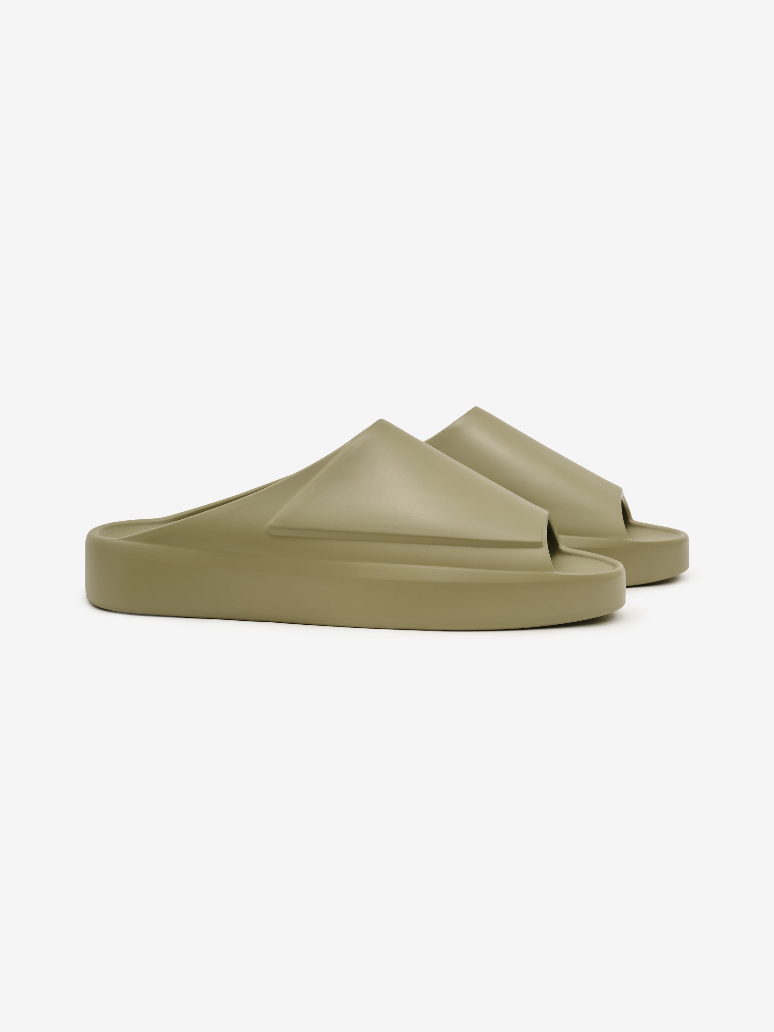 Essentials Los Feliz slip-on footwear in a muted olive tone featuring a smooth, molded upper with geometric folds and a thick cushioned sole designed for modern casual comfort.