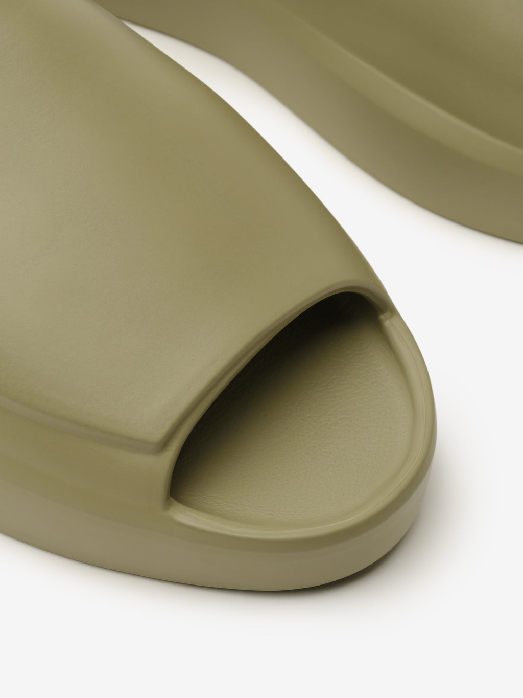 Essentials Los Feliz slip-on footwear in a muted clay tone featuring a smooth, open-toe design with a streamlined upper and a cushioned sole for understated casual comfort.