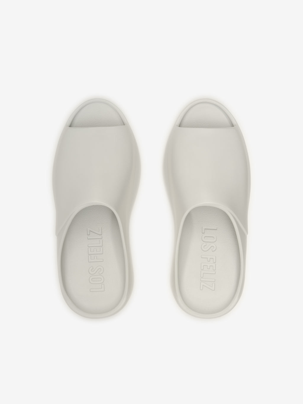 Essentials Los Feliz open-toe slip-on footwear in a light oyster shade, featuring a smooth, streamlined design with a minimalist and modern silhouette for casual wear.