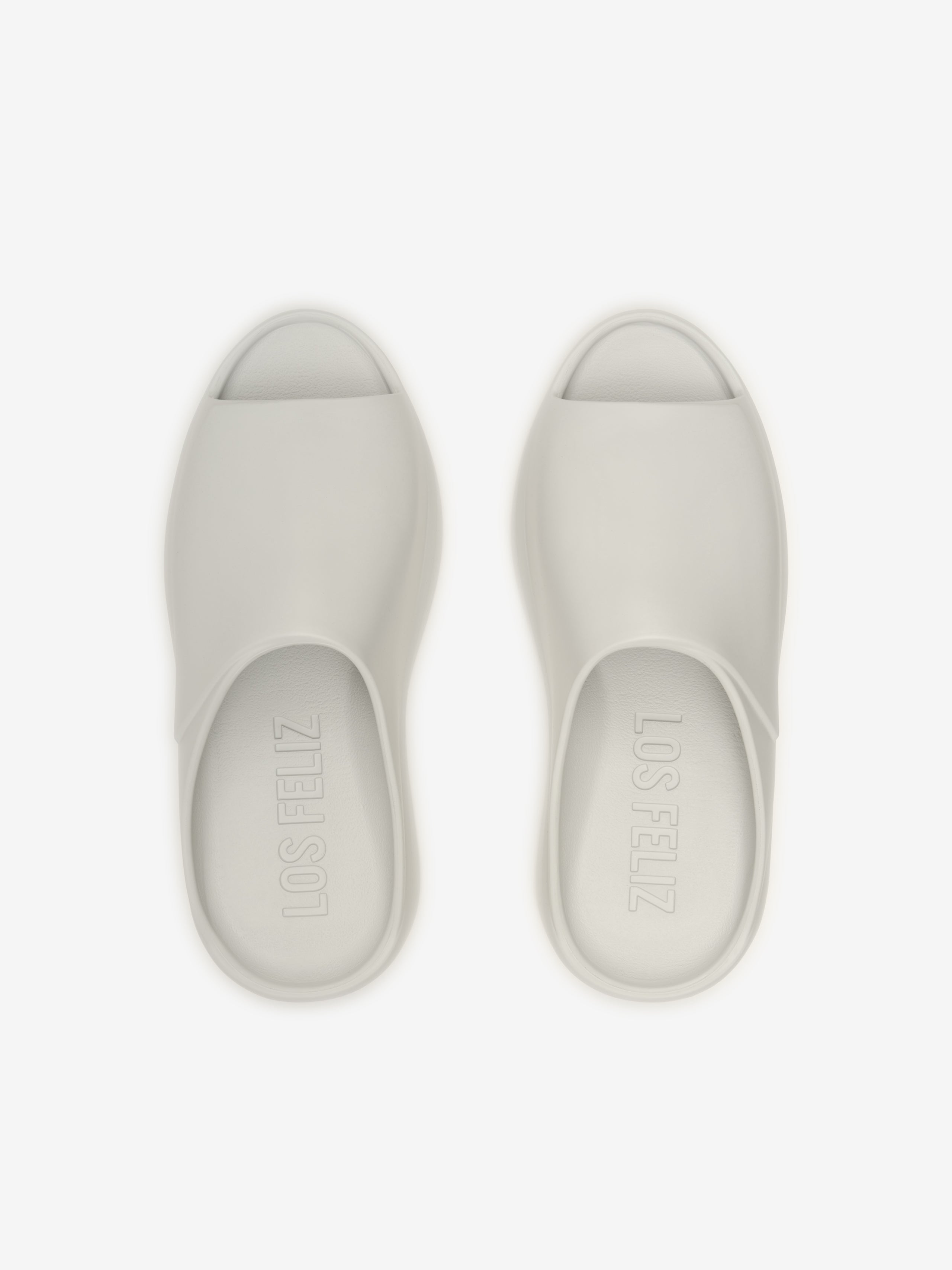 Essentials Los Feliz open-toe slip-on footwear in a light oyster shade, featuring a smooth, streamlined design with a minimalist and modern silhouette for casual wear.