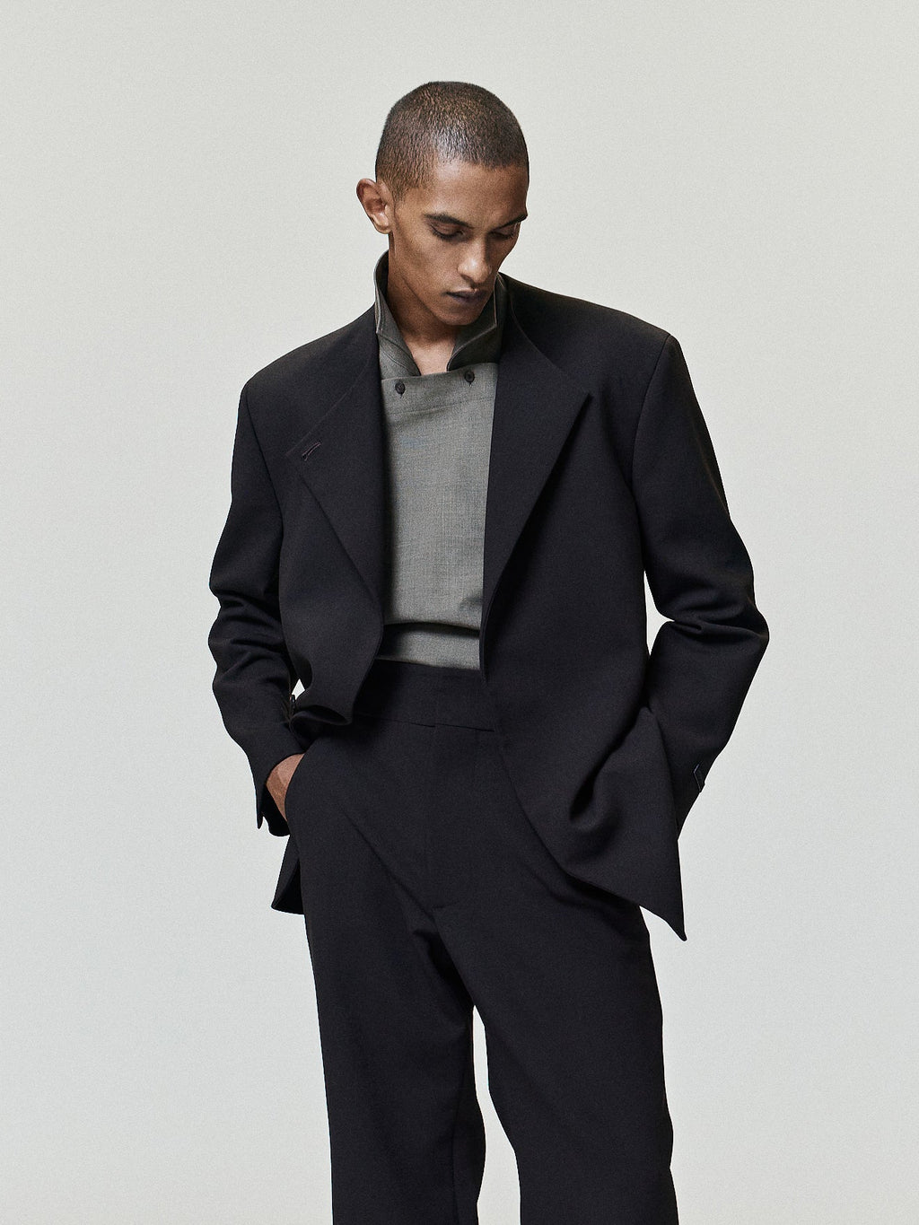 Double Weave Wool Flared Flat Front Pants worn in black with a high waist clean front and subtly flared legs styled with a tailored jacket as Bottoms