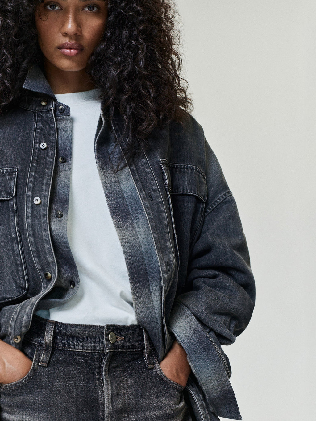 Cotton Rayon Eternal Tee in off white worn under a dark denim jacket with a crewneck collar and relaxed fit visible on model as Tops